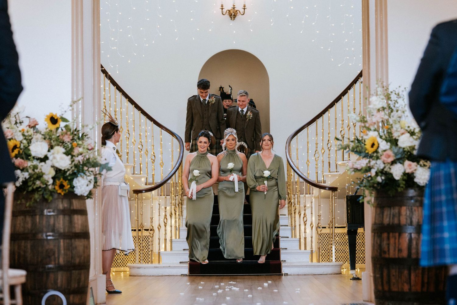 Wedding ceremony in progress under an archway decorated with romantic string lights.
