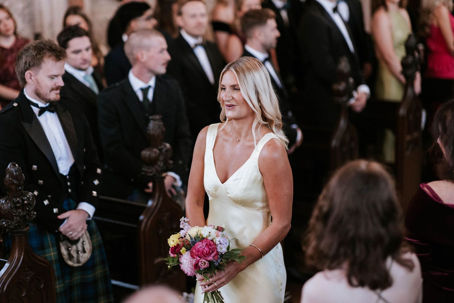 Emotional wedding ceremony moment captured in historic church setting.