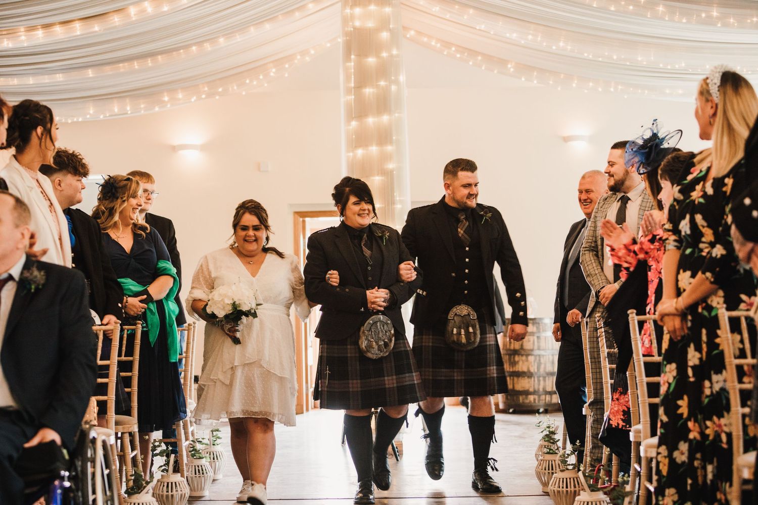 Logie House Wedding Photography. Elegant wedding reception venue with string lights and guests mingling.