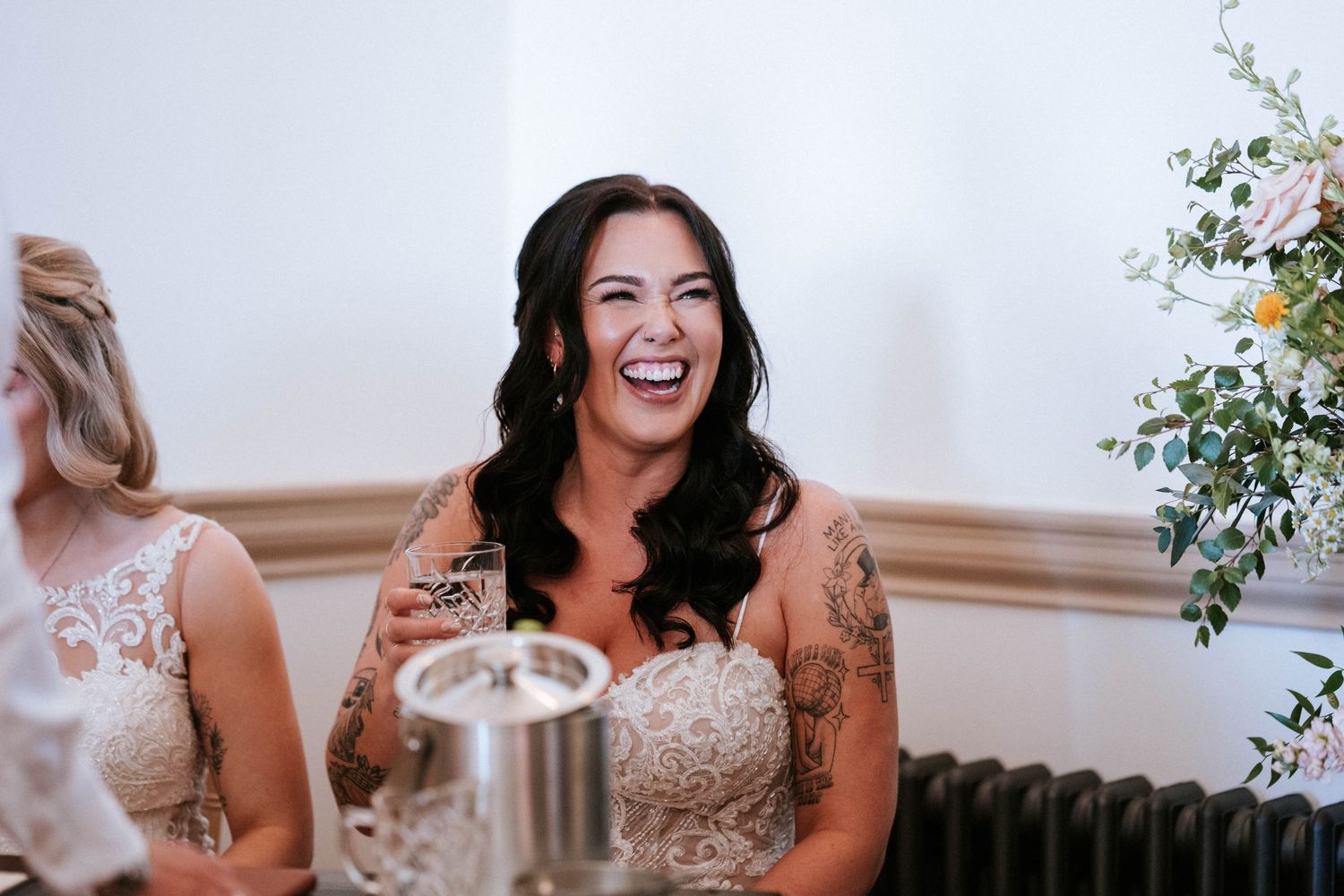 Joyful moment captured during wedding reception with floral decorations.