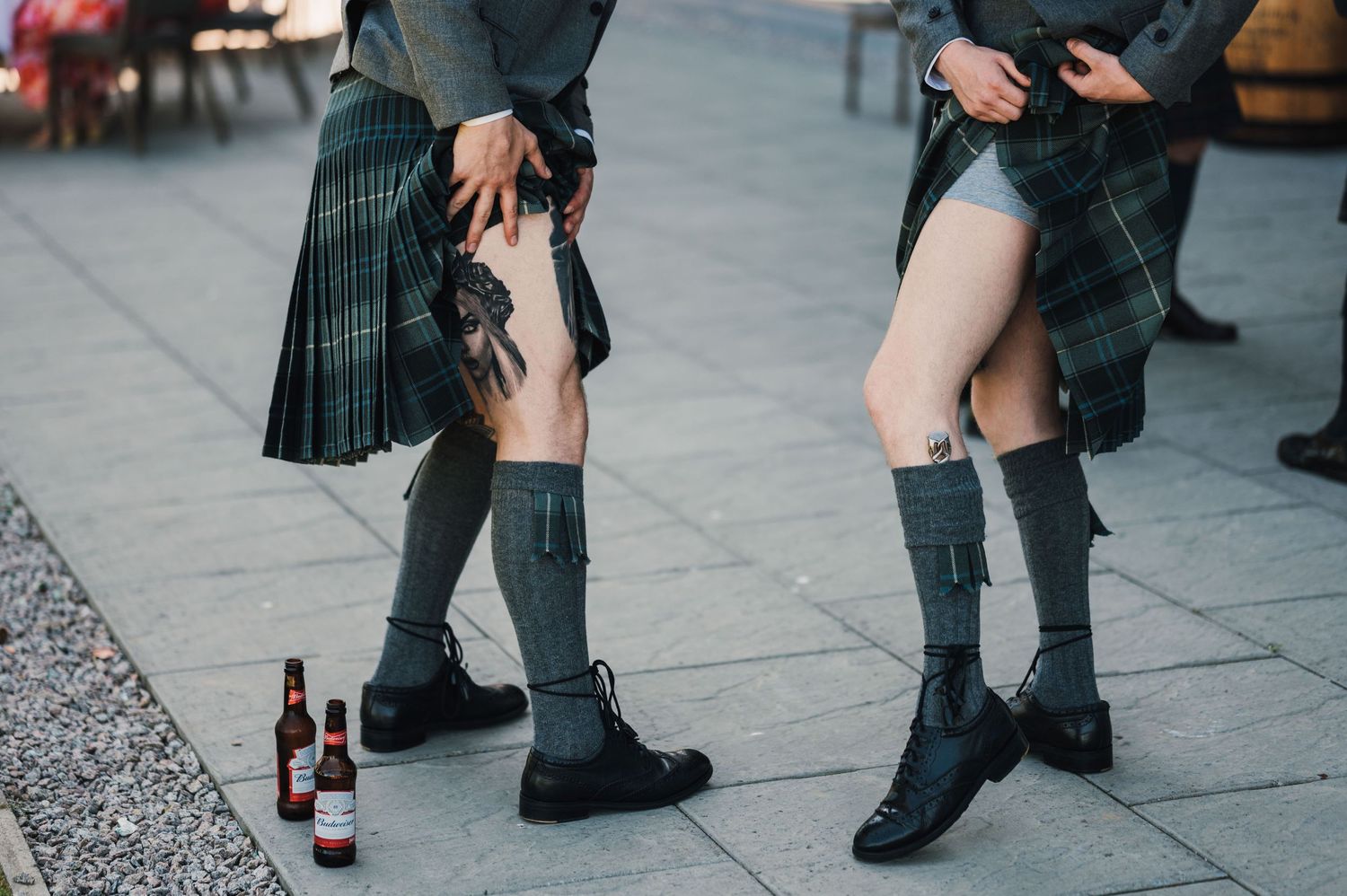 Close-up of traditional Scottish kilt socks and boots worn at a wedding celebration.