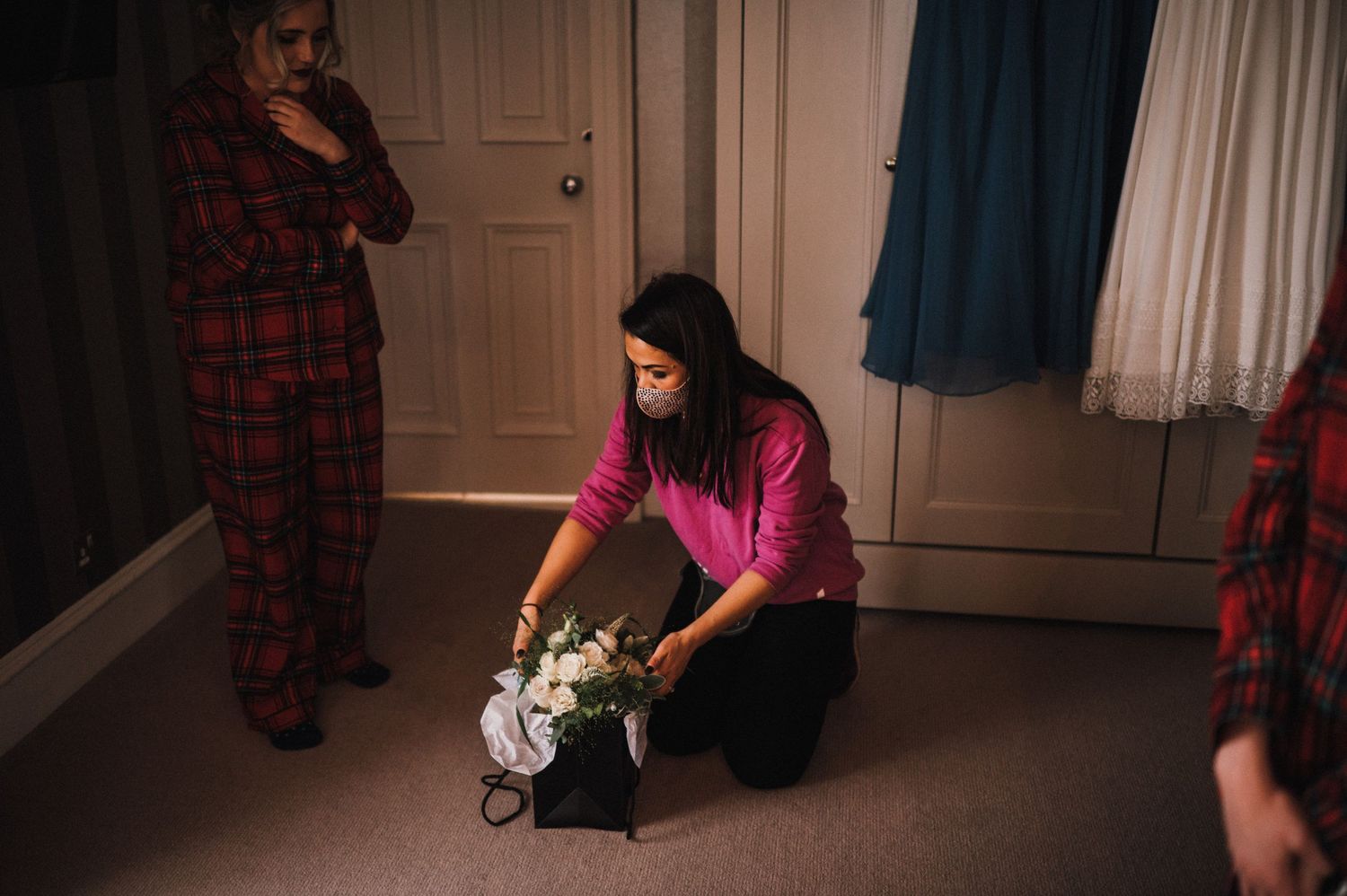 Getting ready scene in bedroom with plaid robes and casual attire.