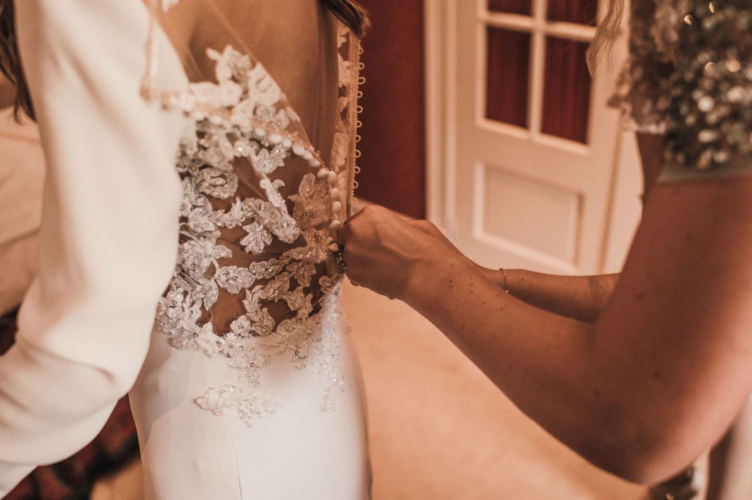 Close-up detail of lace wedding dress bodice.