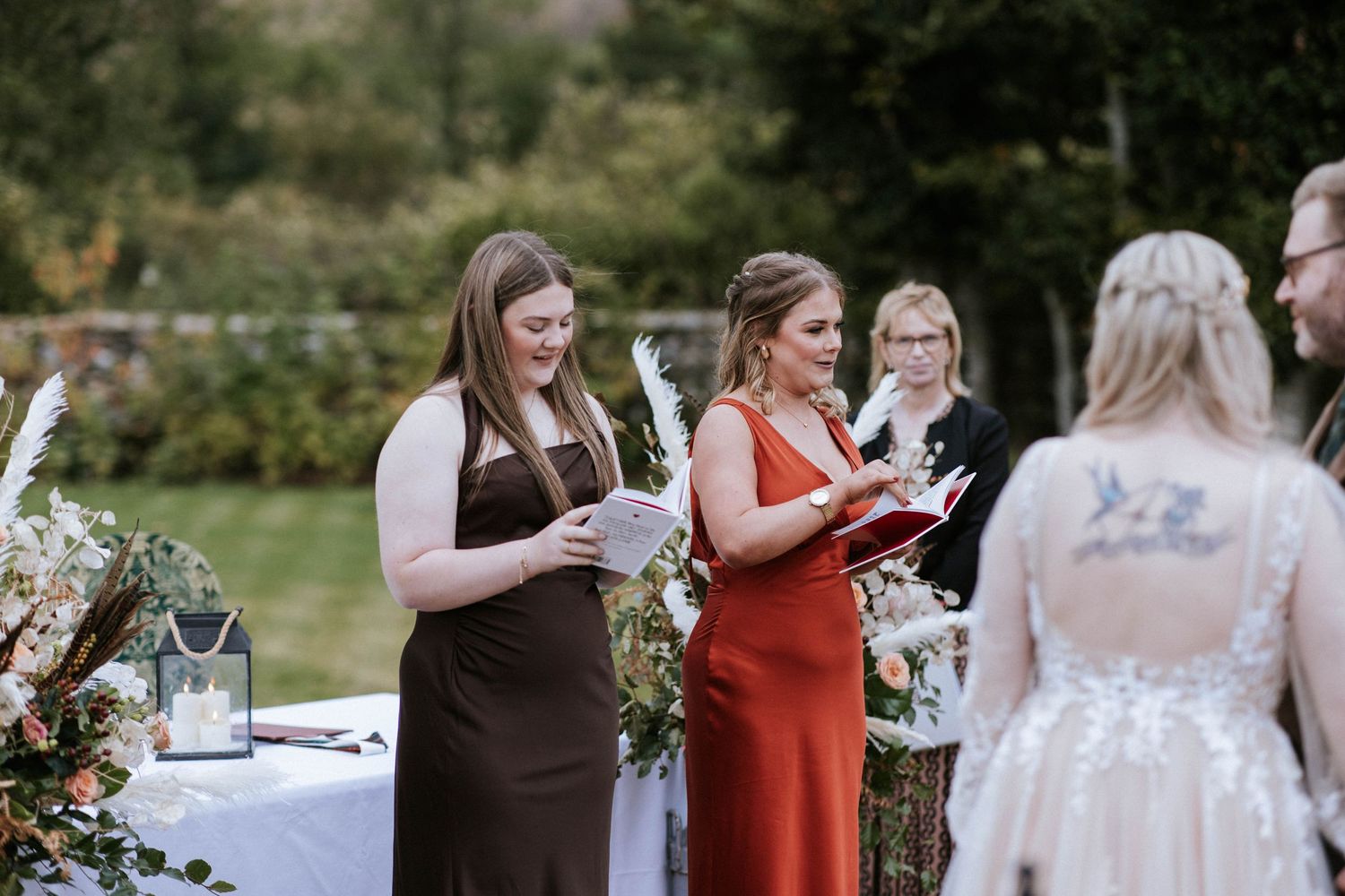 Wedding guests gather outdoors for a casual reception celebration with drinks and conversation.