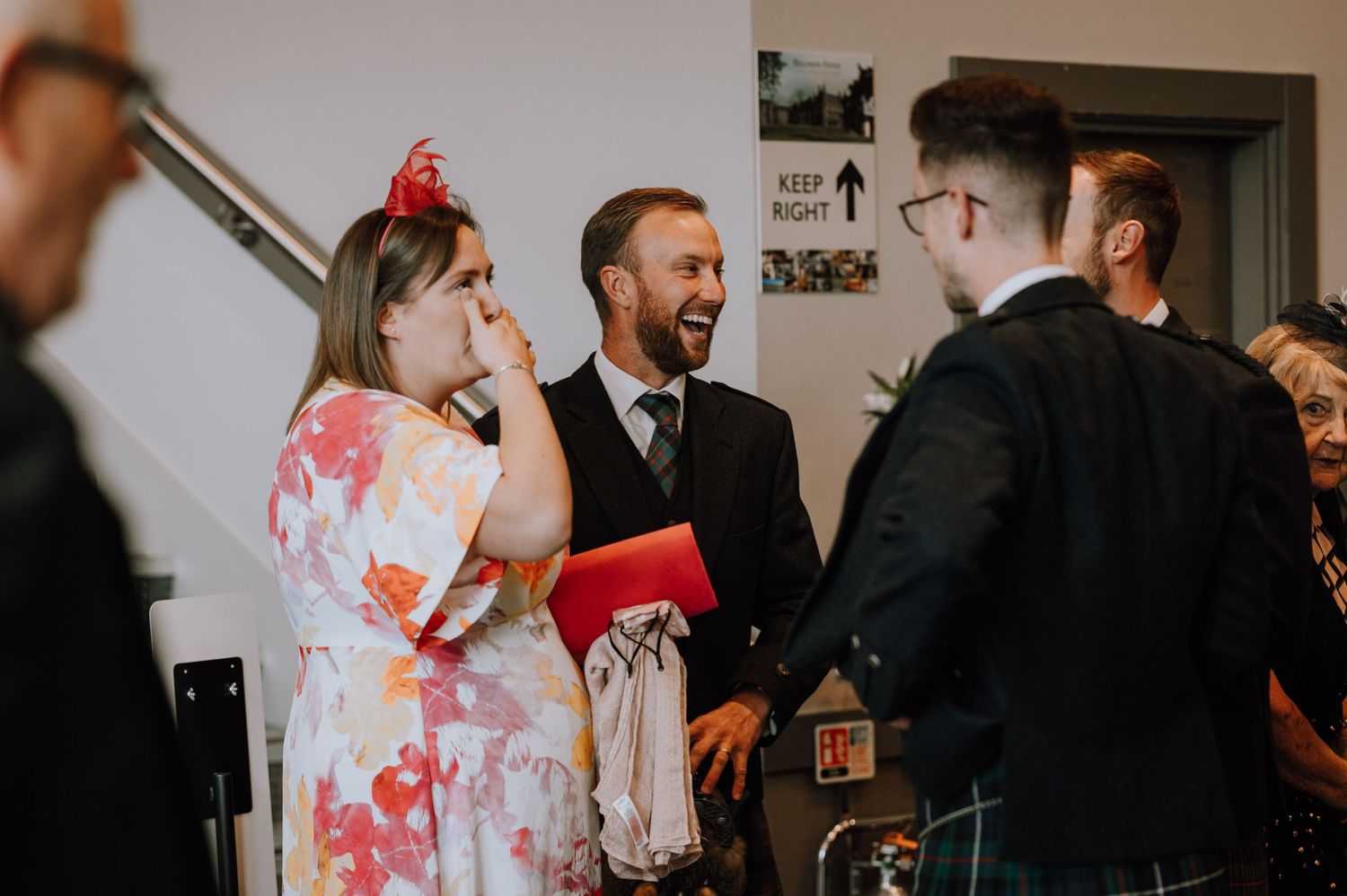 Social gathering at an indoor venue with guests mingling and conversing.