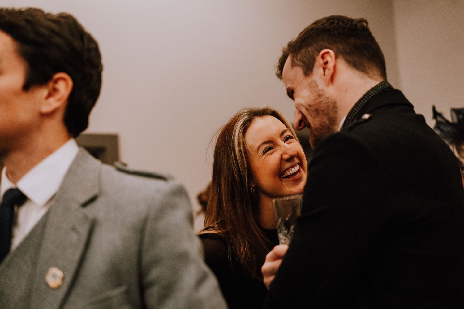 Wedding guests enjoying candid moments at a reception party.