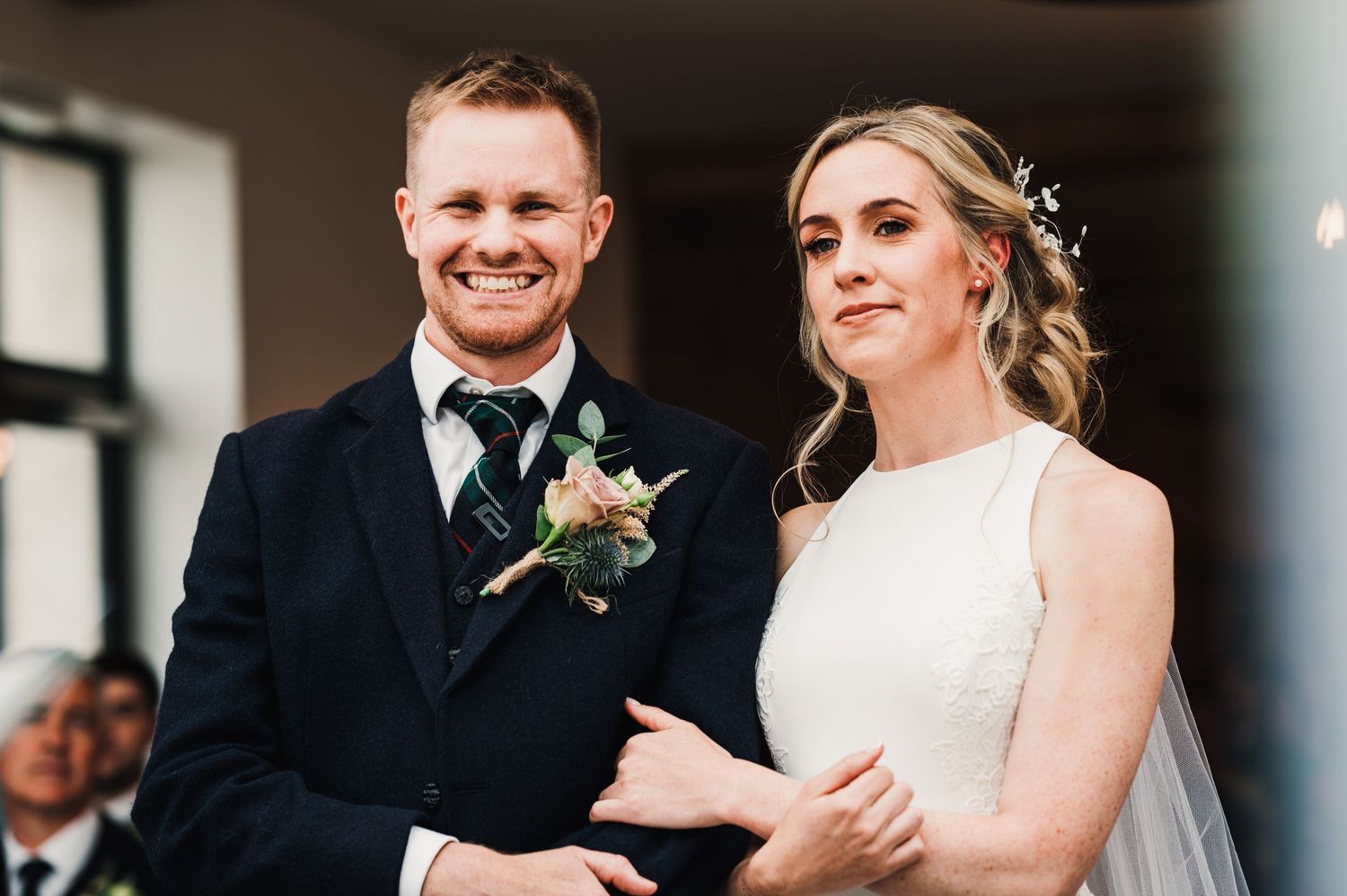 Elegant couple sharing a candid moment during their wedding ceremony.