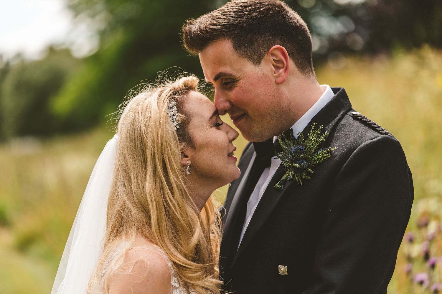 Intimate wedding portrait moments captured in a natural outdoor setting.