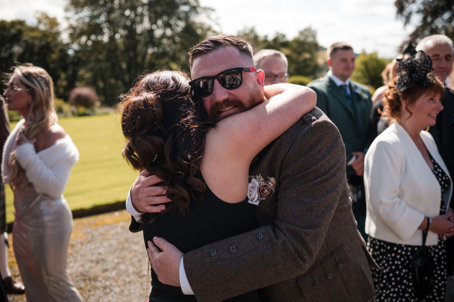 Aberdeen Wedding Photography. Joyful guests embrace and celebrate at an outdoor wedding reception.