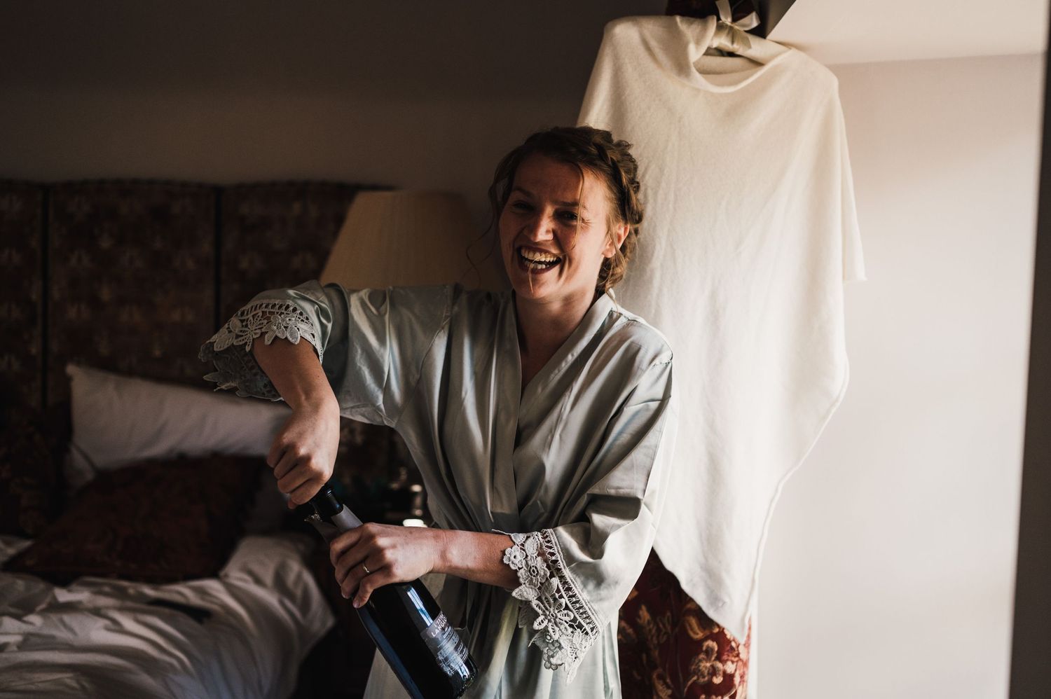 A joyful moment captured during morning preparations in a cozy bedroom setting.