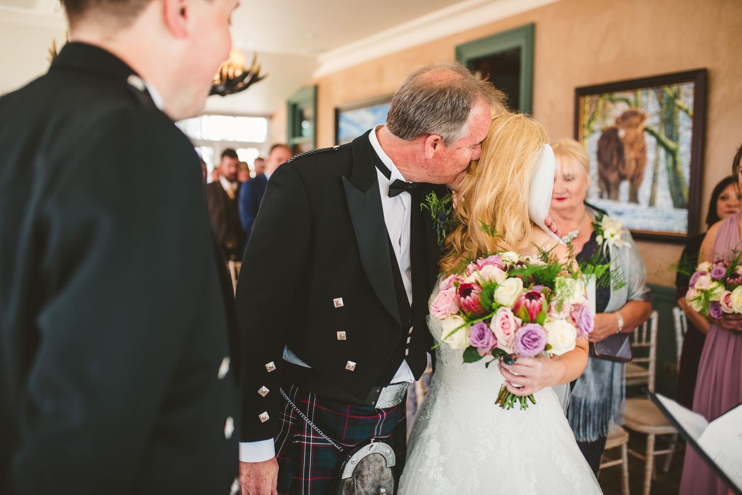 Wedding ceremony moments captured in a traditional church setting with Scottish kilts and formal attire.