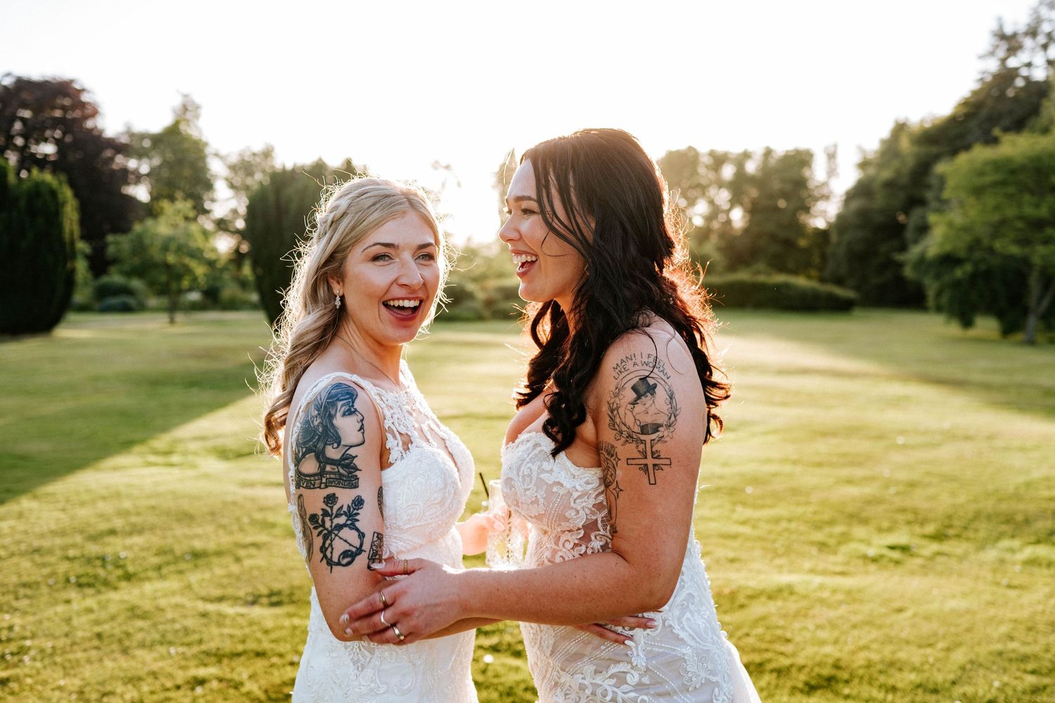 Aberdeen Wedding Photography. Joyful wedding couple laughing together in sunlit garden setting.
