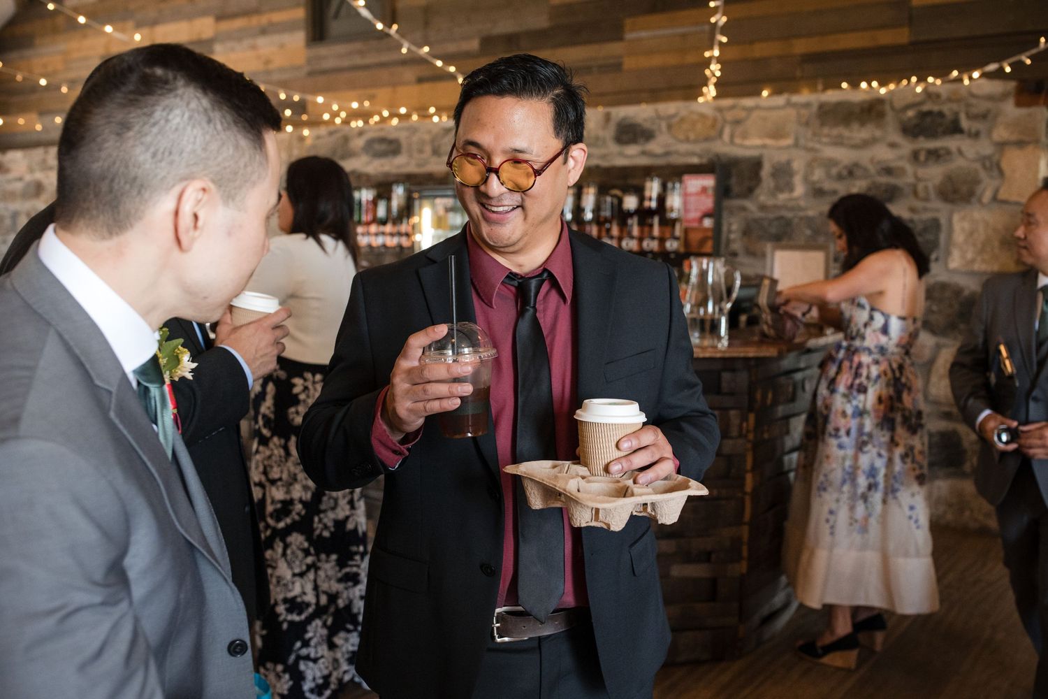 Wedding celebration in a rustic stone venue with string lights creating a warm ambiance.