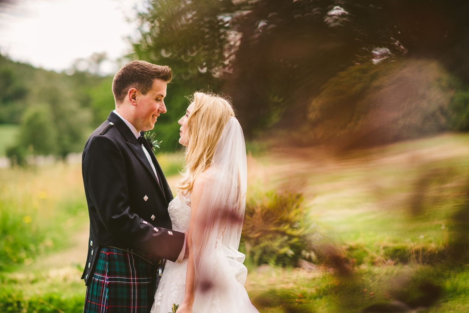 Romantic outdoor wedding photography with soft focus and natural lighting.
