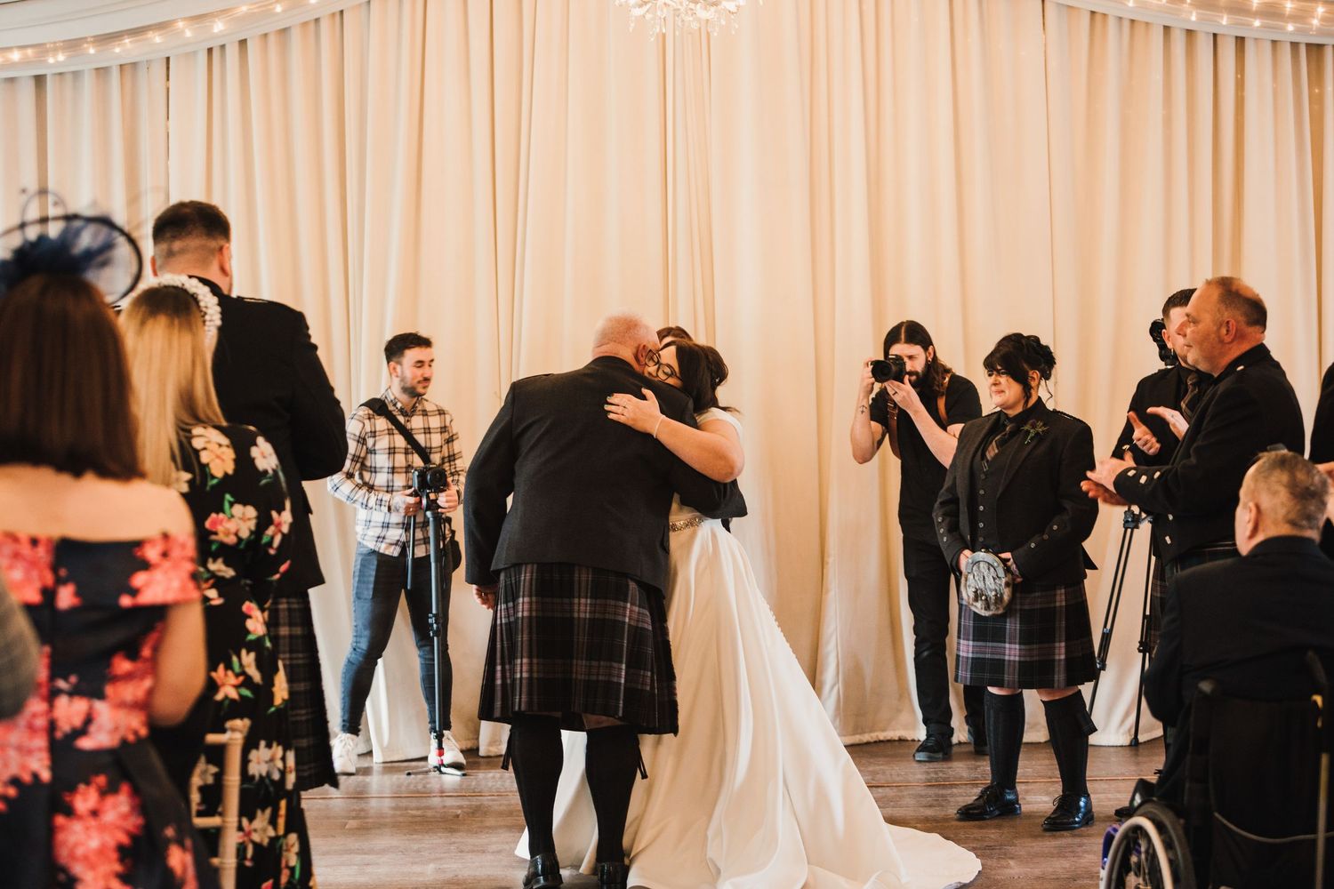 Logie House Wedding Photography. Wedding celebration in an elegant venue with string lights and white draping.