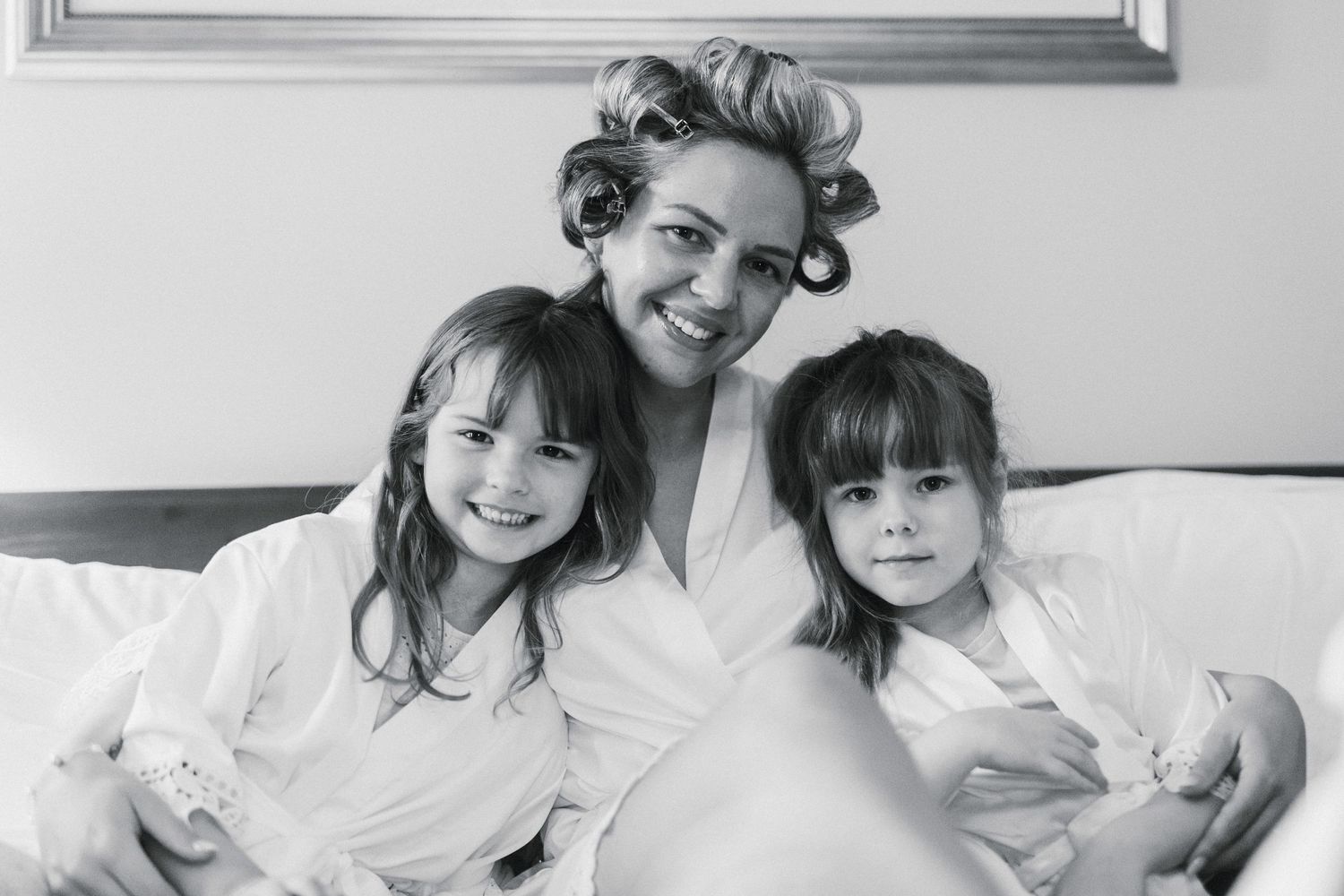 Black and white intimate portrait of family members sharing a tender moment.