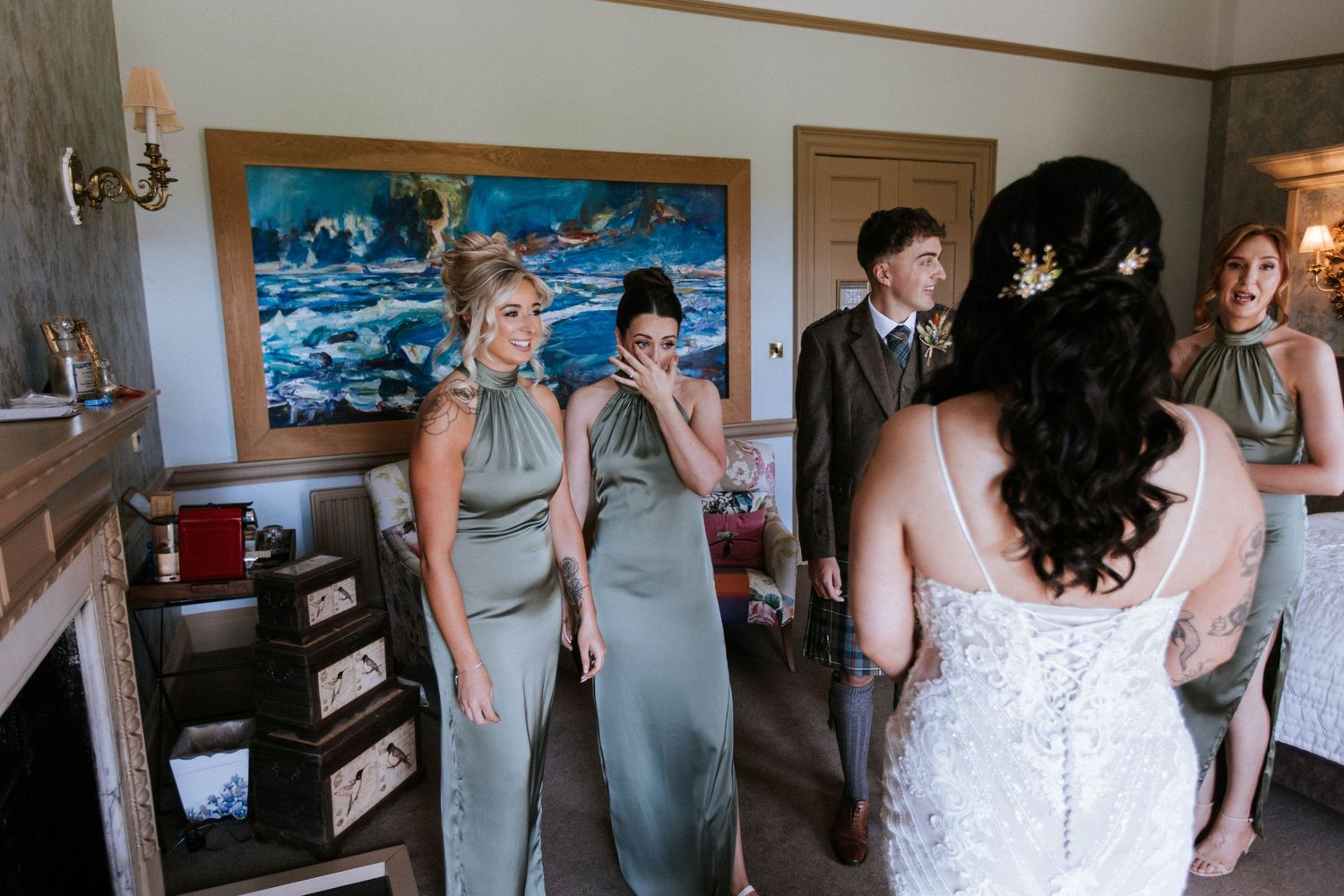 Fasque Castle Wedding Photography. Wedding party lined up in formal attire against interior wall with elegant decor.