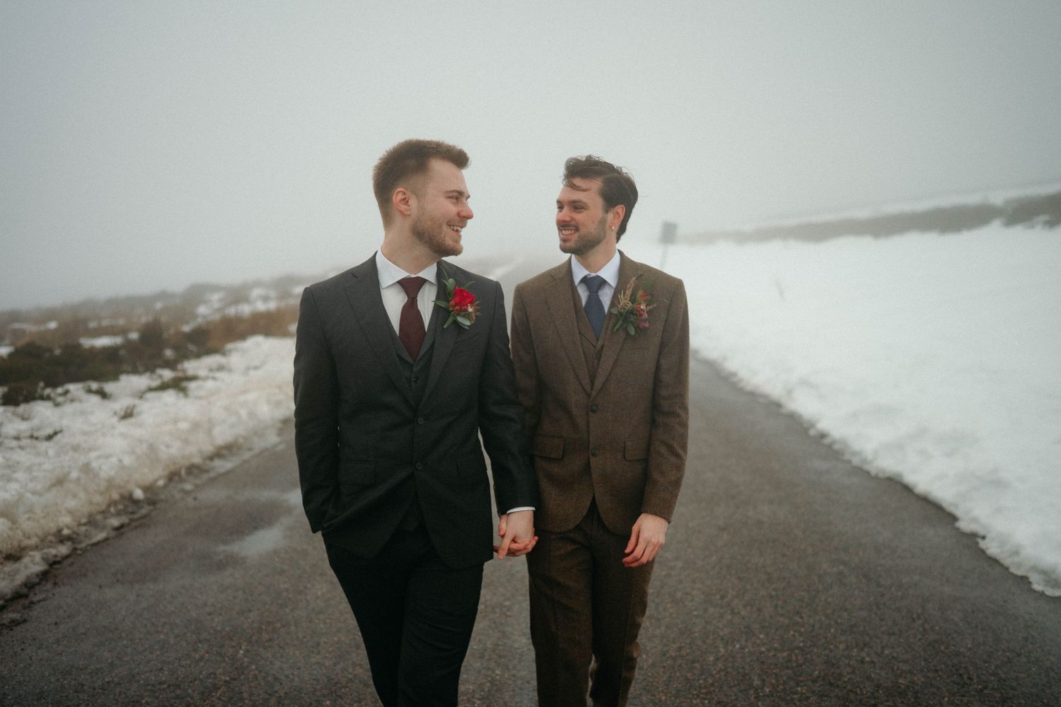 Drumtochty Castle  Wedding Photography. Two people share an intimate moment in formal wear against a snowy winter landscape.