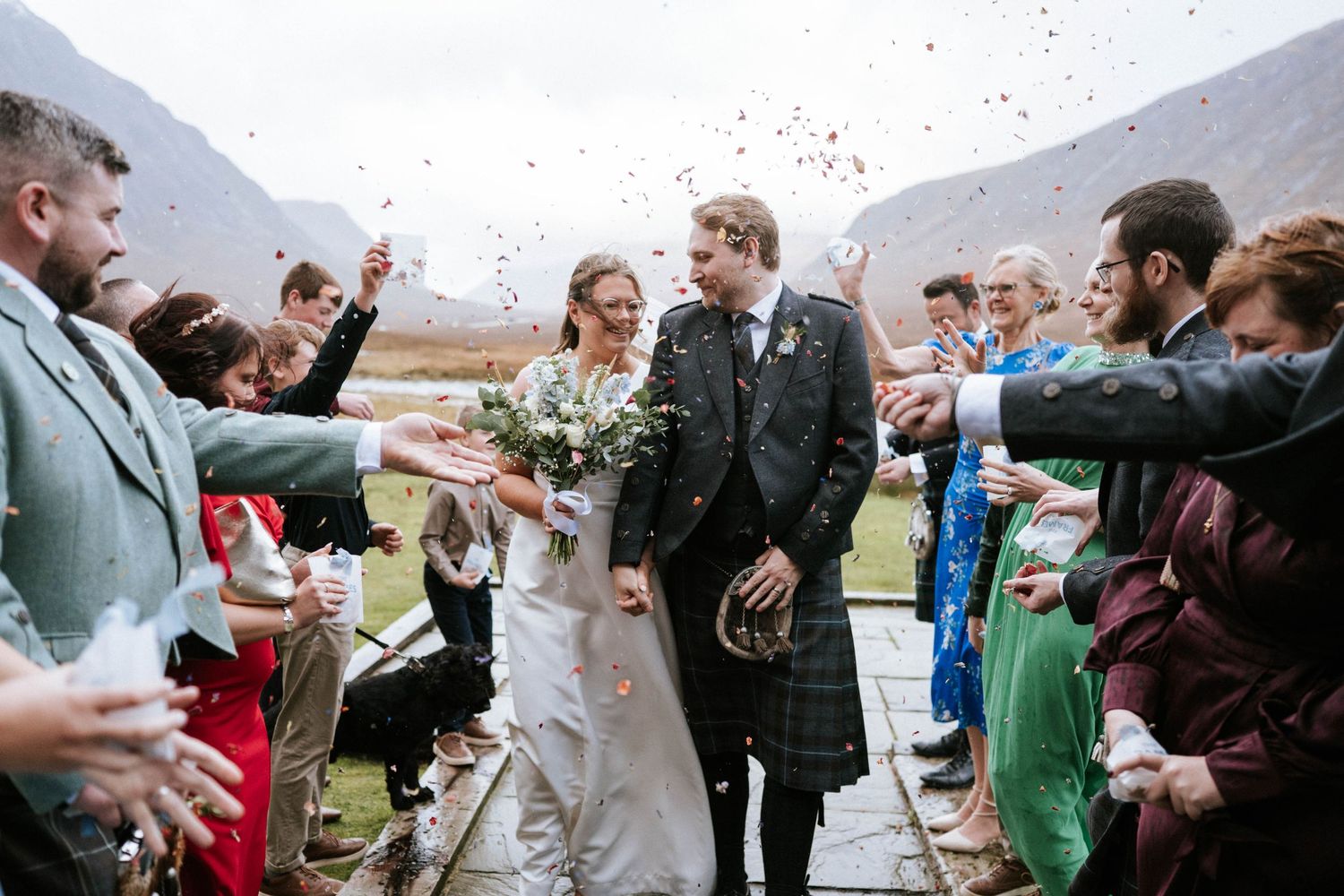 Joyful celebration with confetti being thrown at a mountain wedding ceremony.