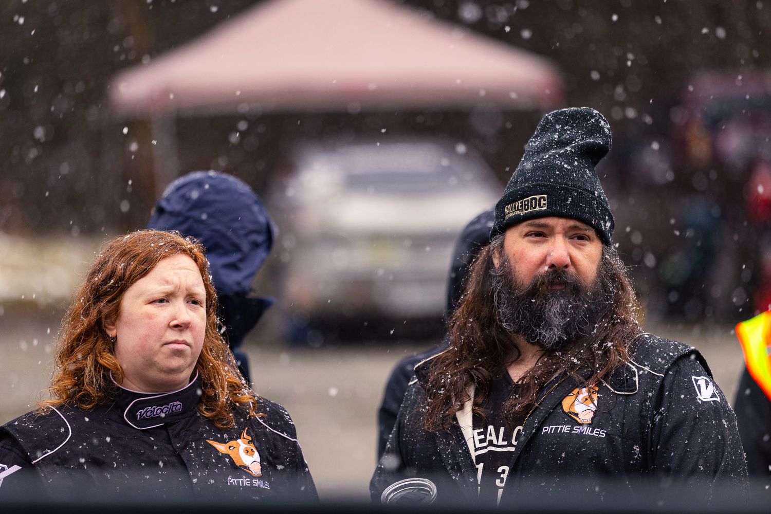 Spectators watching outdoor winter event in snowy conditions.
