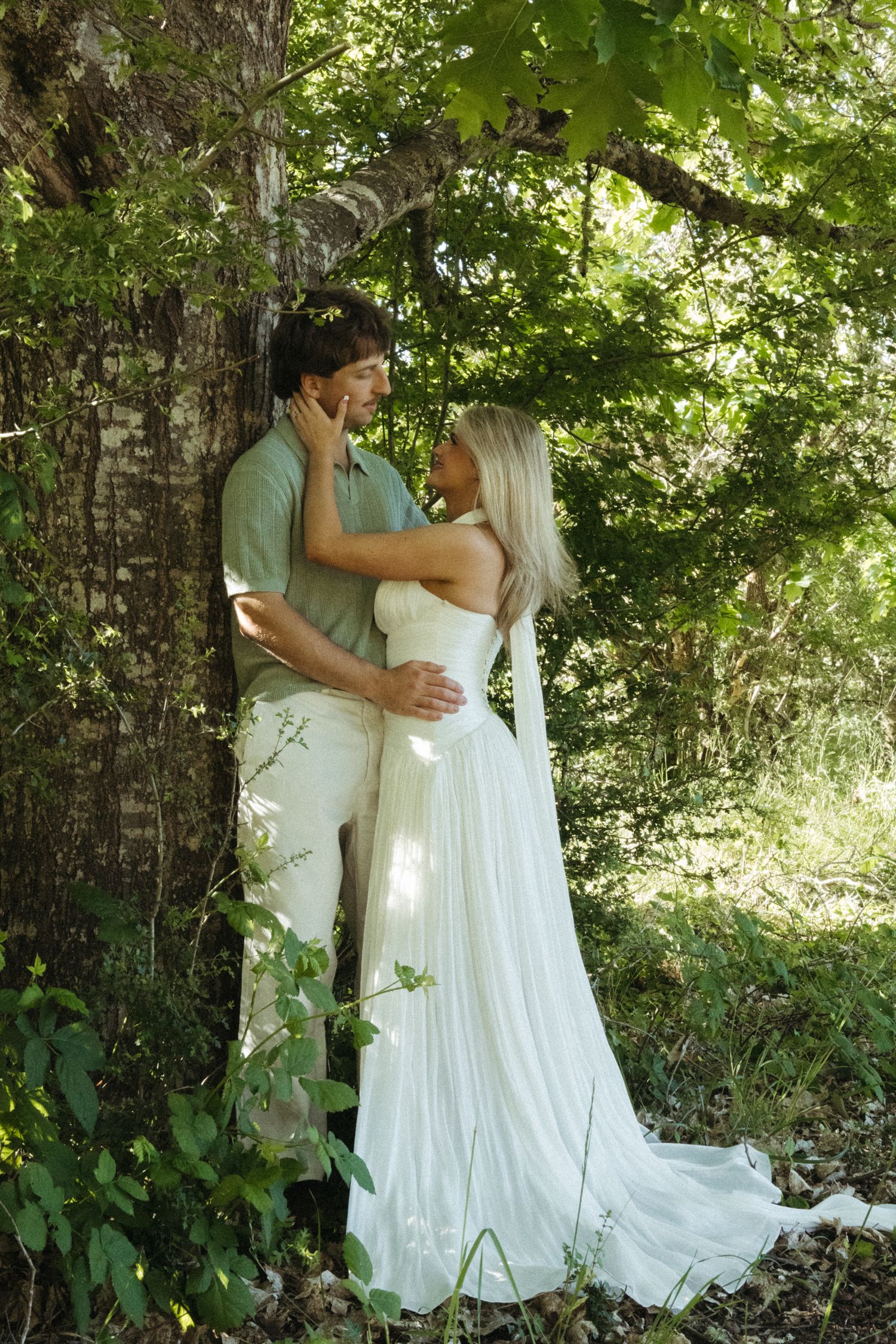 Oregon golden hour engagements under the trees stands the bride and groom to be!