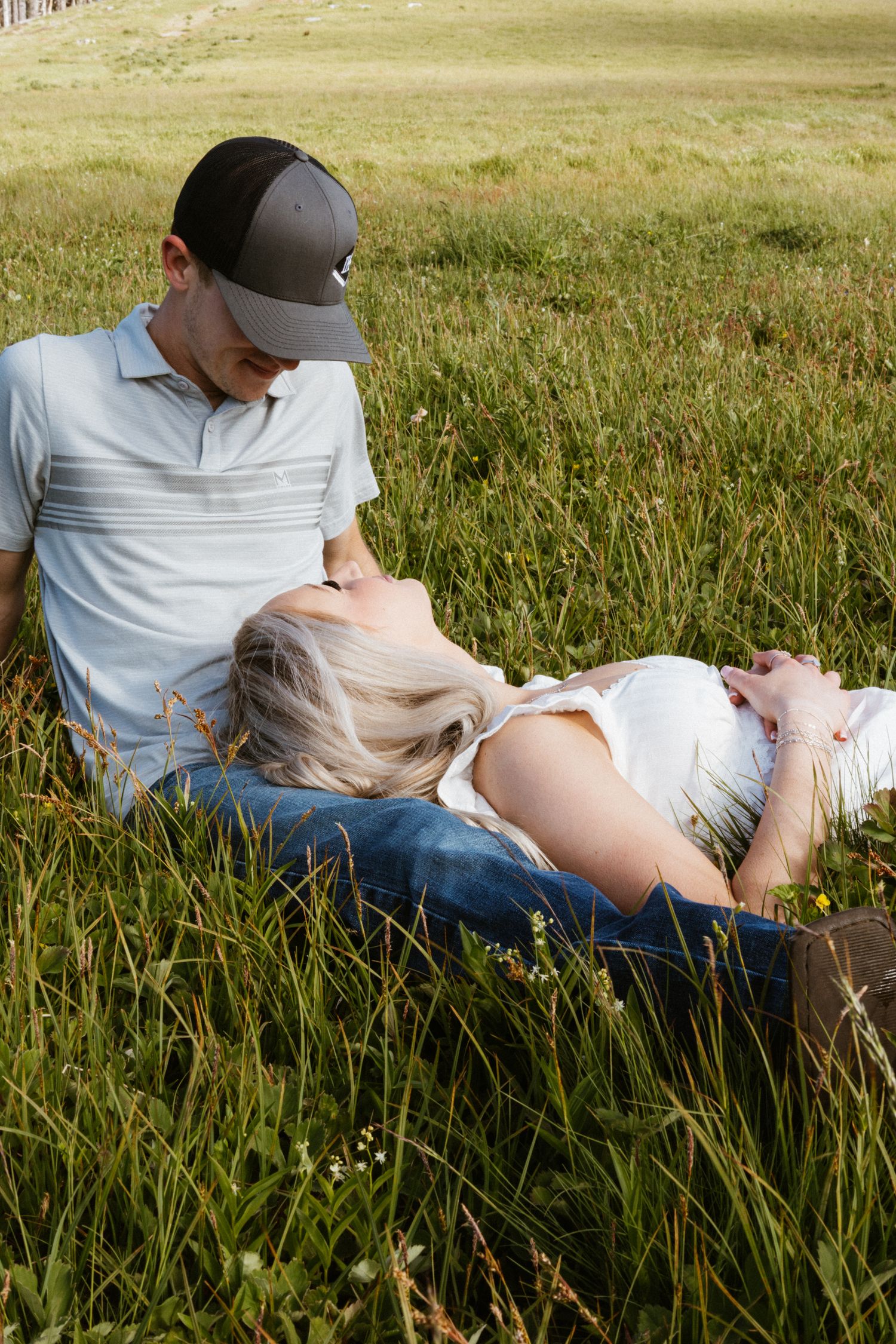Couples session with Portland Wedding photographer candid moments laying in grass together.