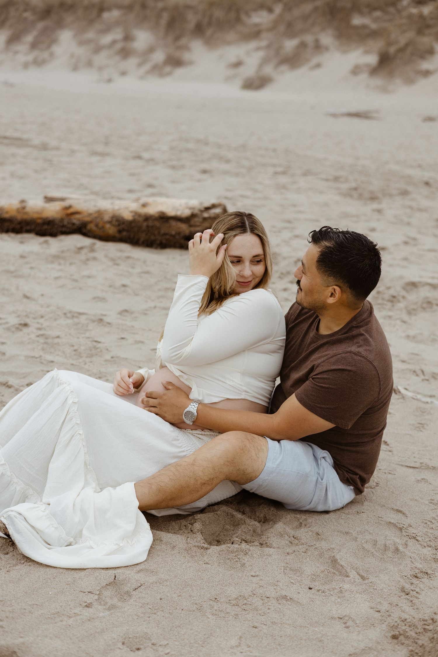 Oregon Couple celebrating last moments of pregnancy before bringing in their little onw on Oregon Coast beach