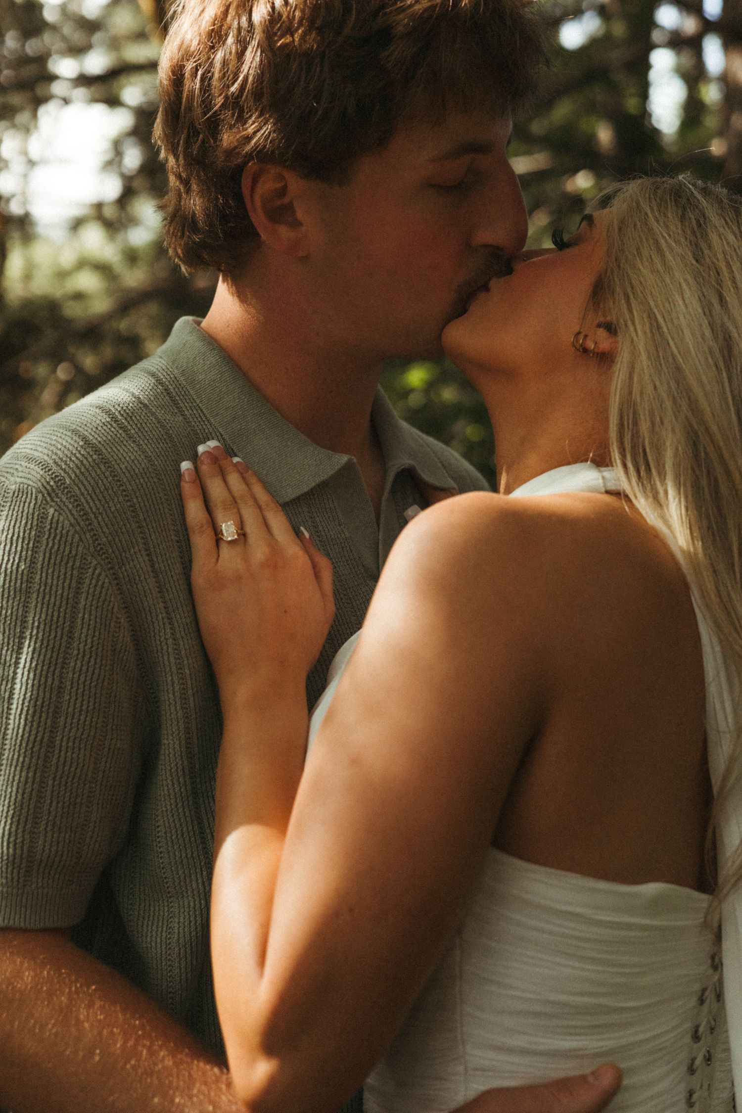 Engagements close up couple kissing in golden hour meadow PNW