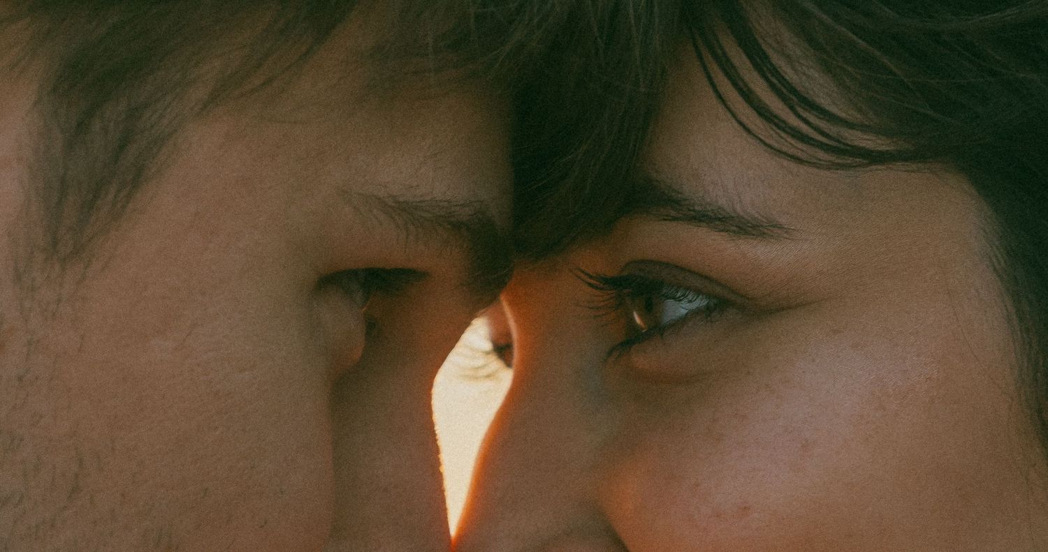 Pacific City Oregon Couples session captured by Oregon Photographer Andi during golden hour. Couple lovingly look into eachothers eyes.