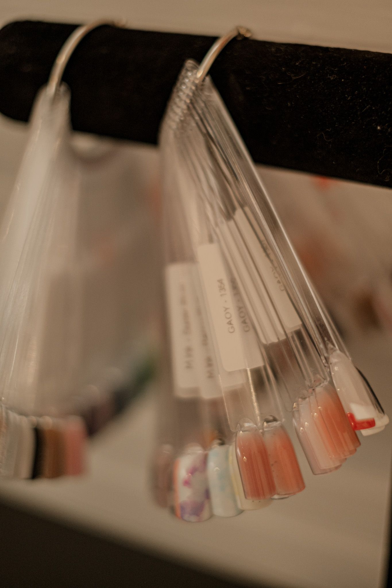 Blurred view of clear plastic sample tubes in a display rack.