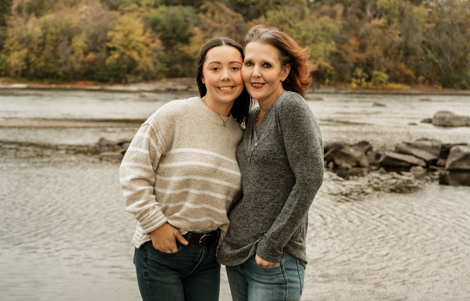 Two people share a candid moment together by the water's edge.