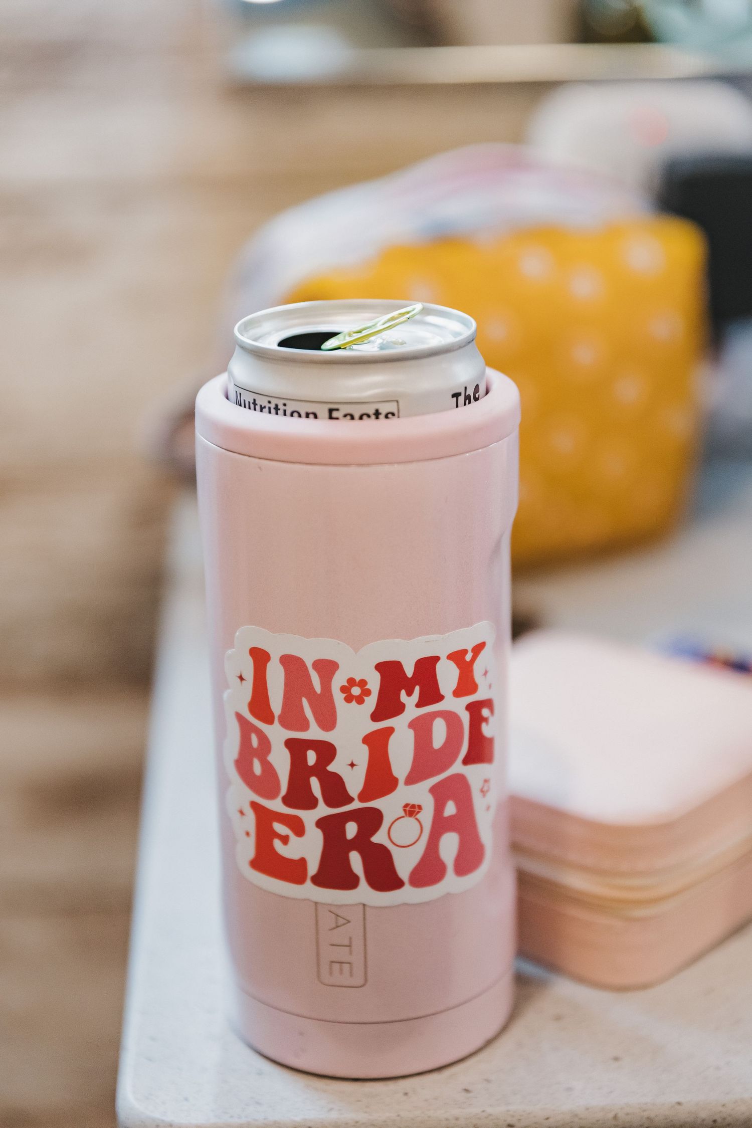 Pink insulated can cooler with In My Bride Era text, perfect bridal party accessory for bachelorette celebrations.
