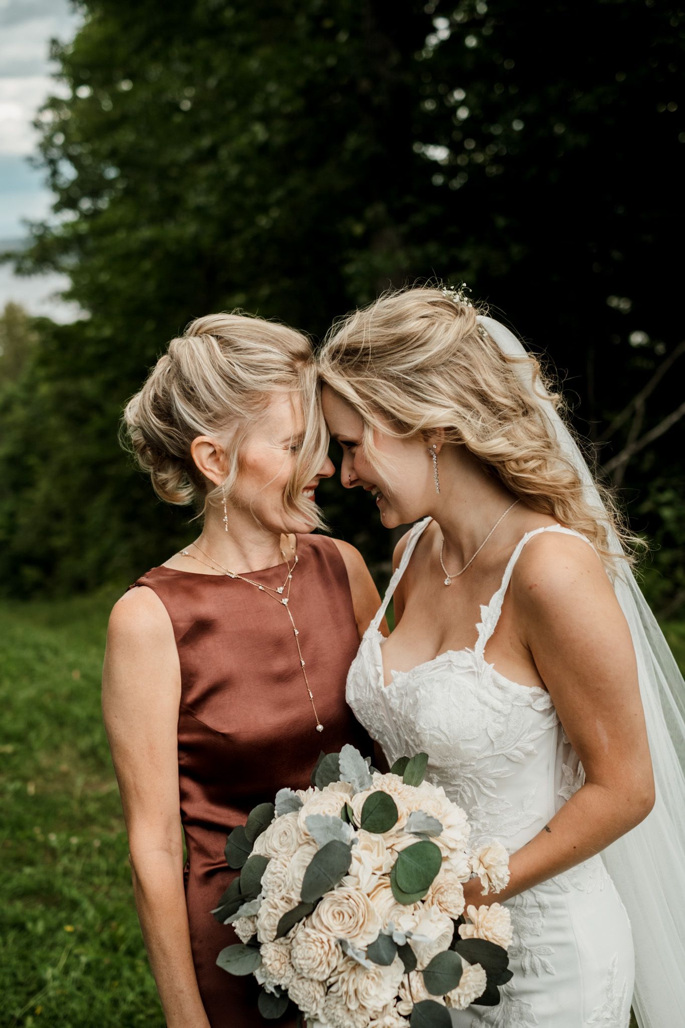 Close-up of bridal bouquet with white roses and eucalyptus leaves.
