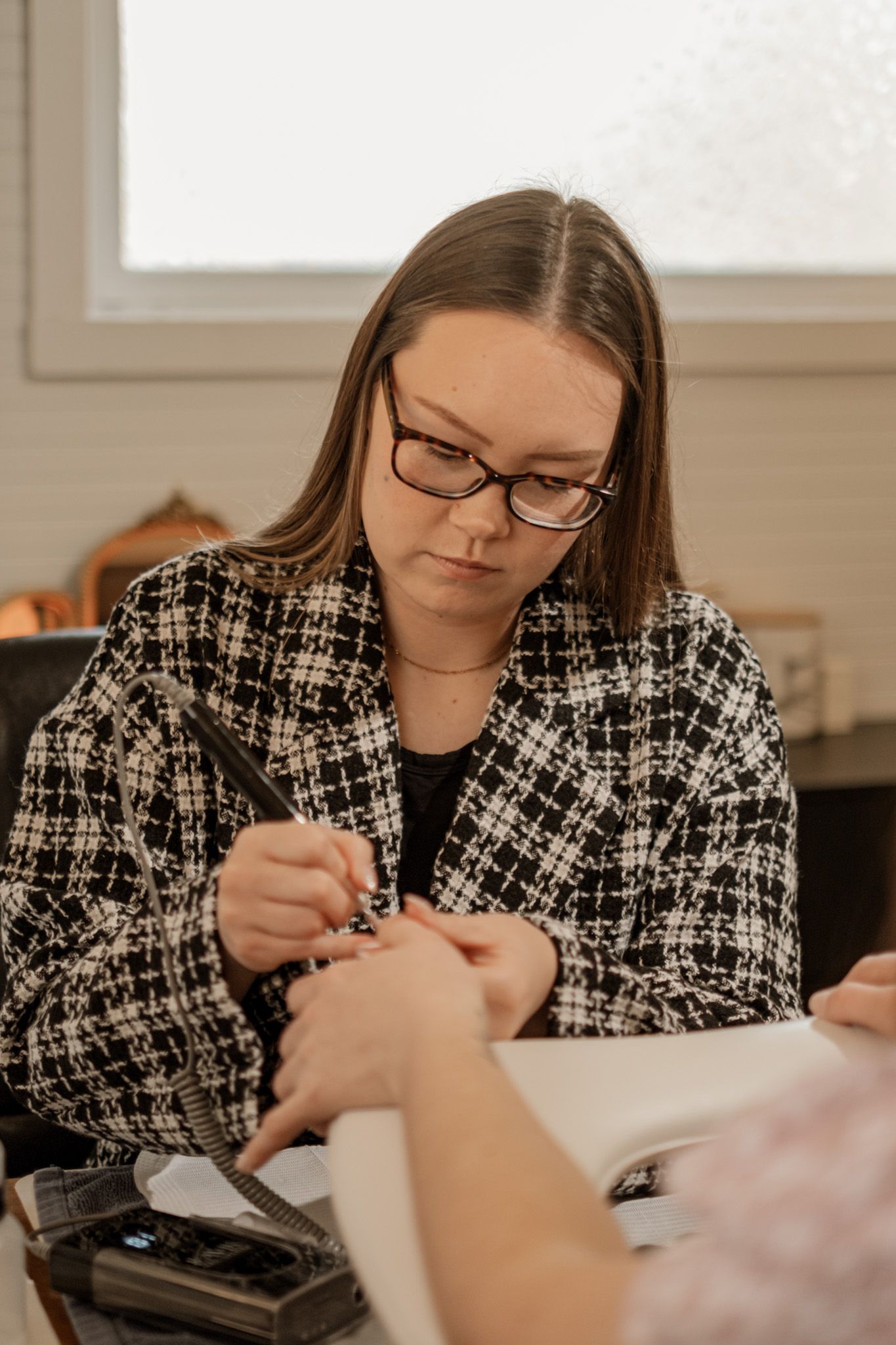 Professional nail care service being performed with precision tools and equipment.