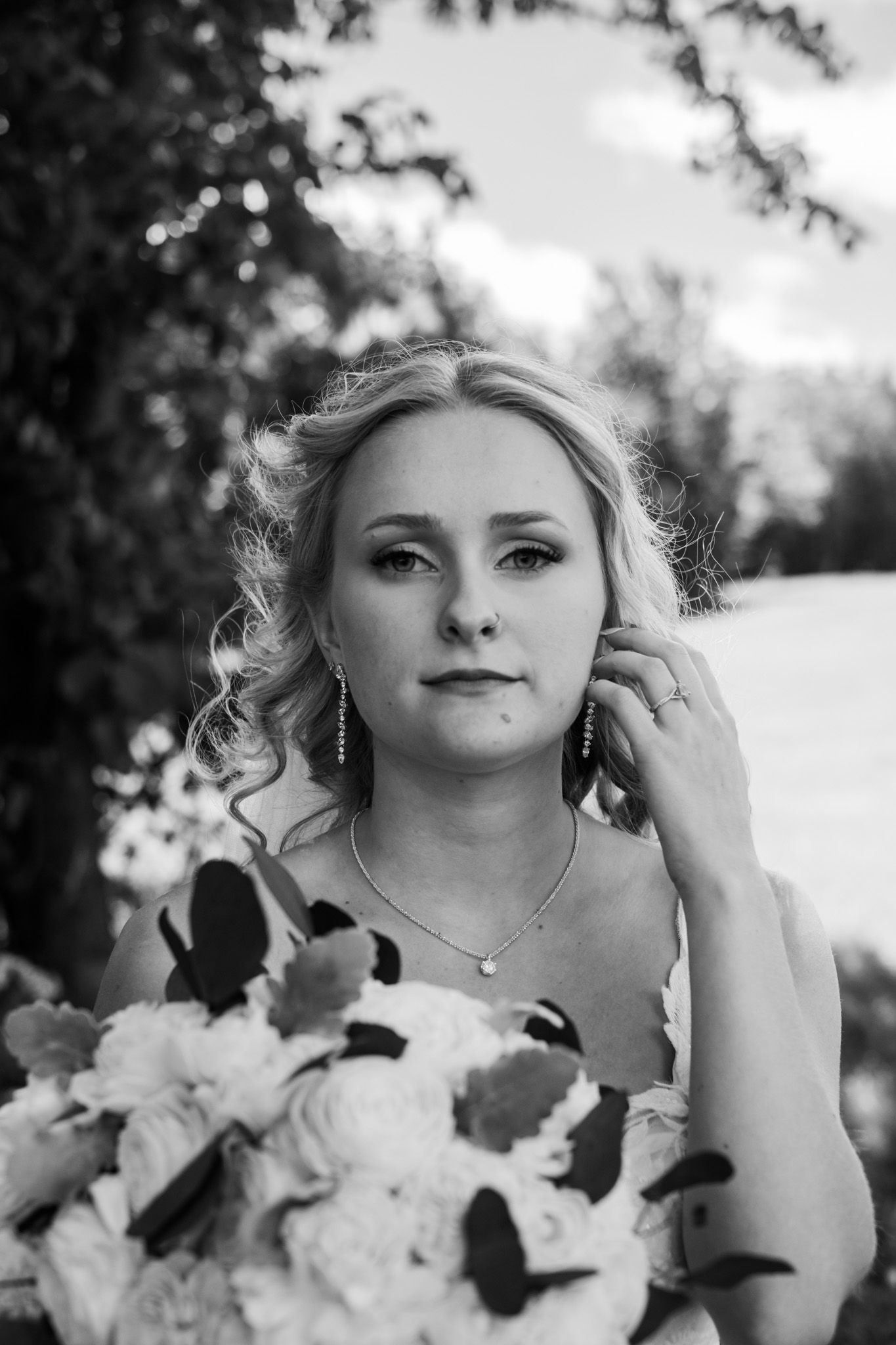 Black and white bridal portraits with white flowers and delicate jewelry.