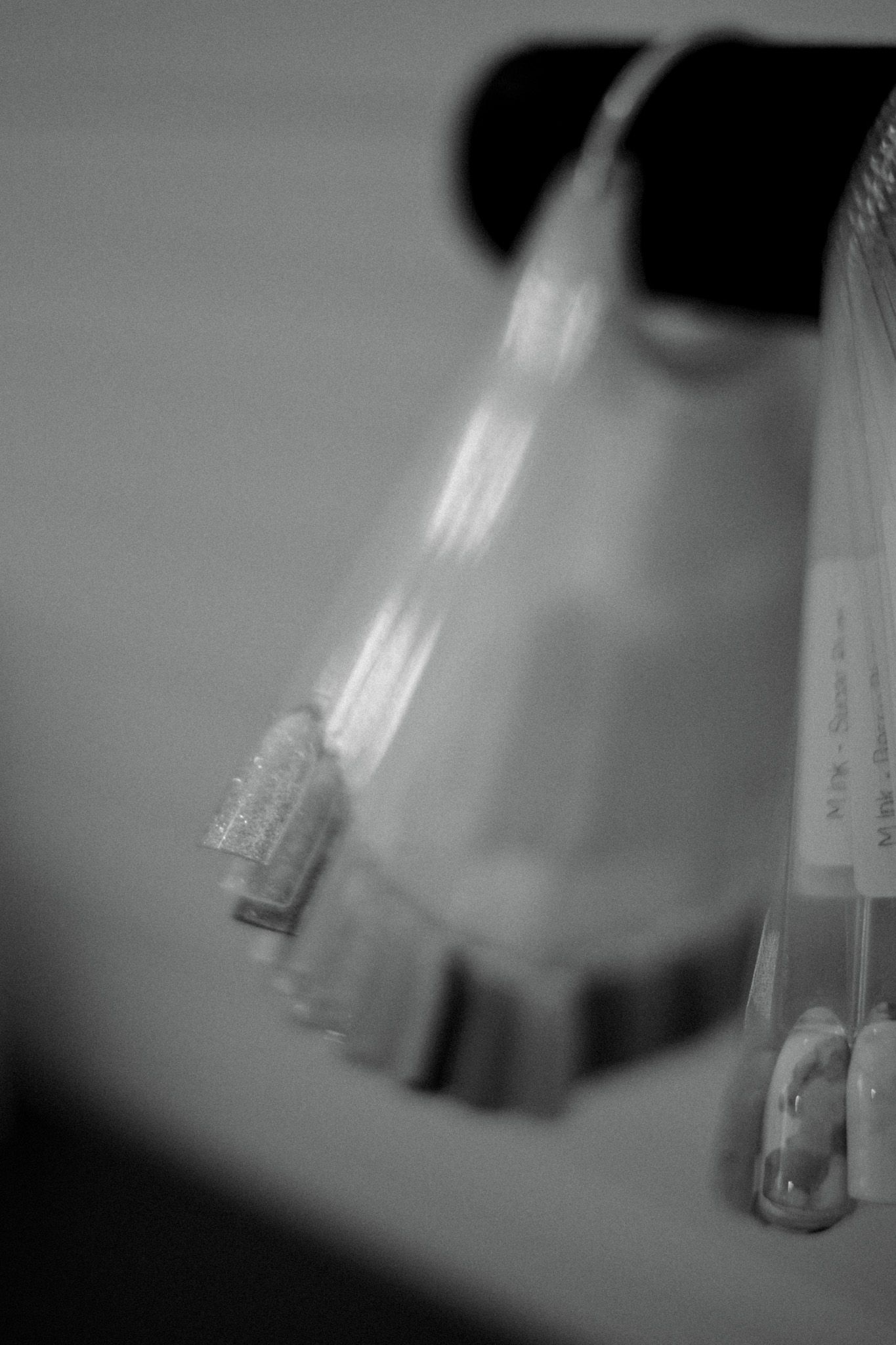 Abstract black and white close-up of transparent laboratory test tubes.