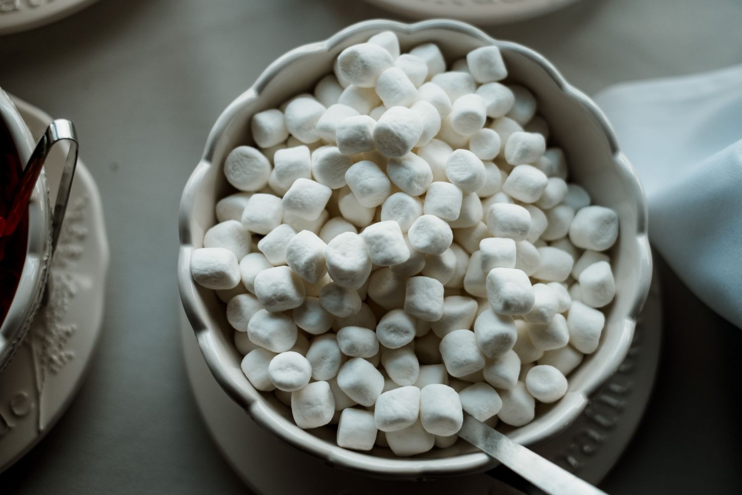 White marshmallows served in elegant ceramic bowl at dessert table.
