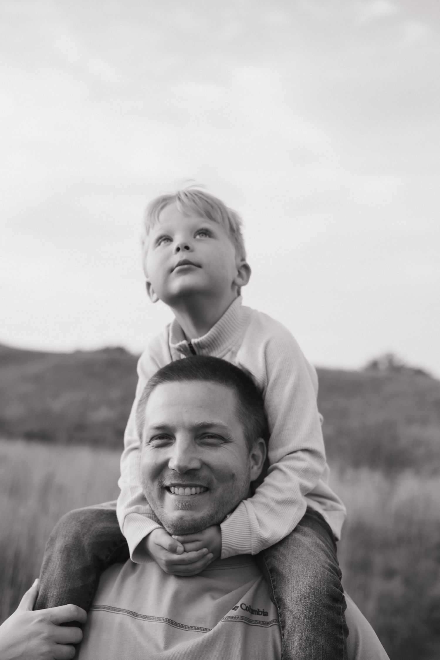 A heartwarming black and white portrait captured in an outdoor setting.