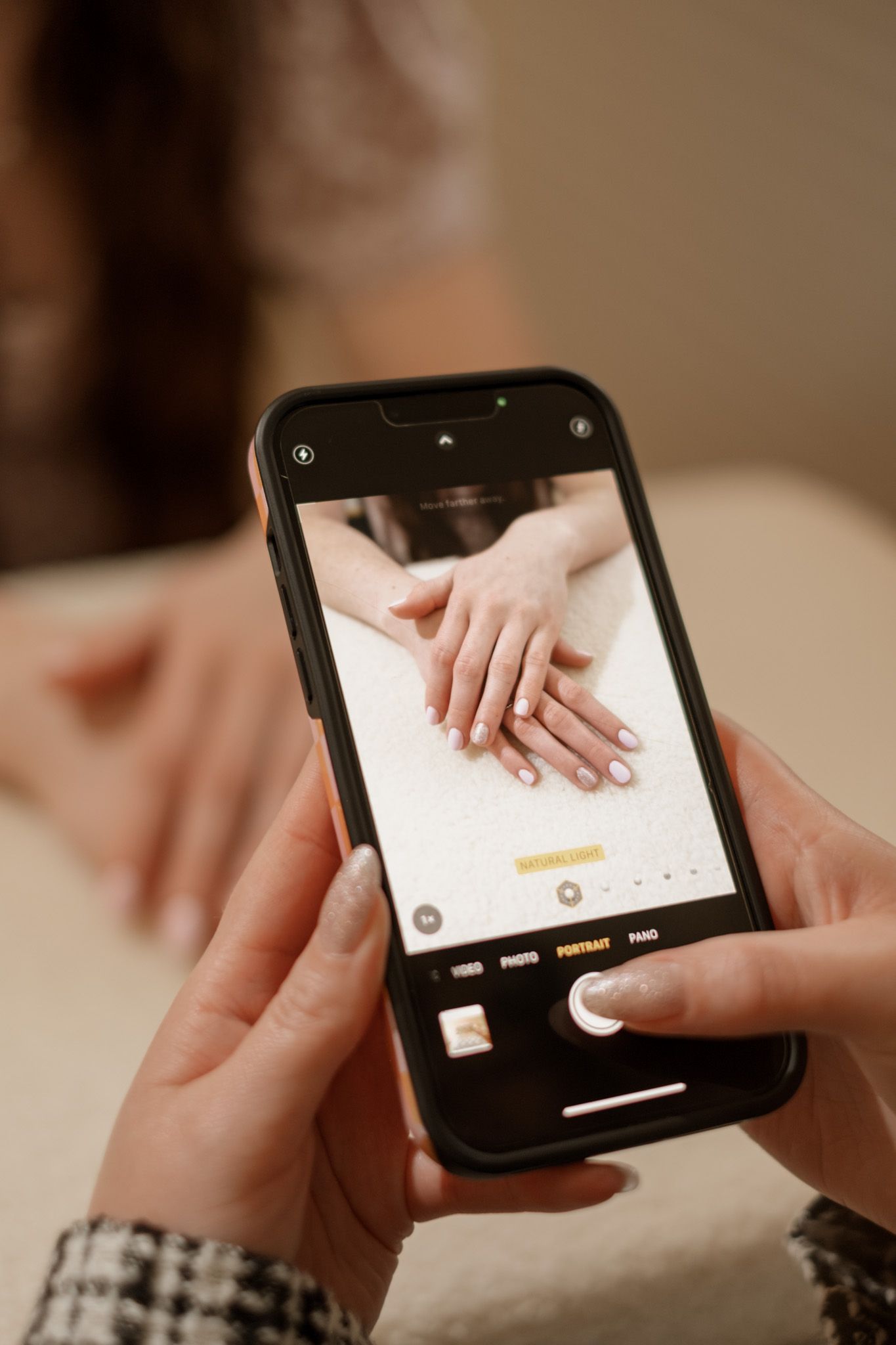 Close-up of hands using smartphone interface showing touch gestures.
