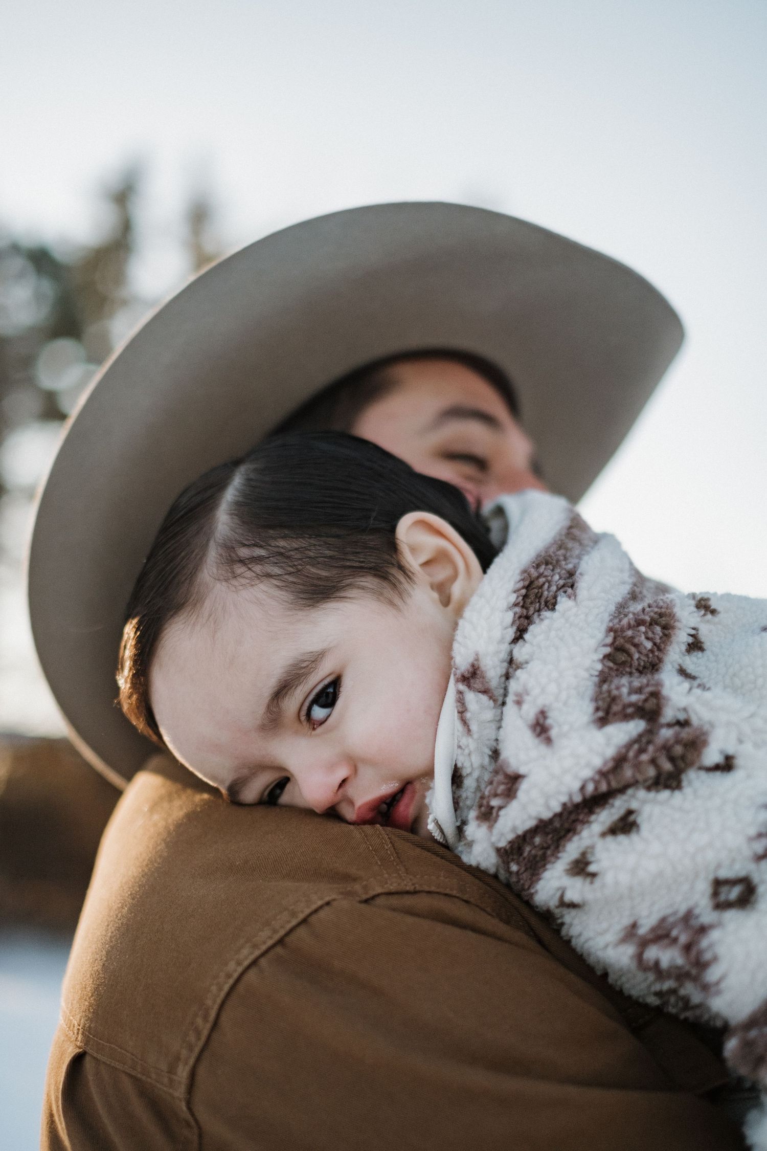 Close-up winter portraits showing tender moments between family members.