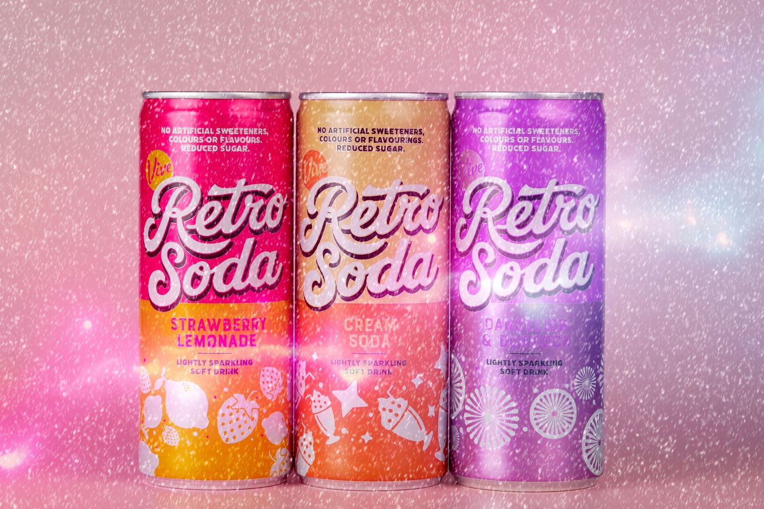 Three vintage-style retro soda cans in pink and orange tones with sparkly background.