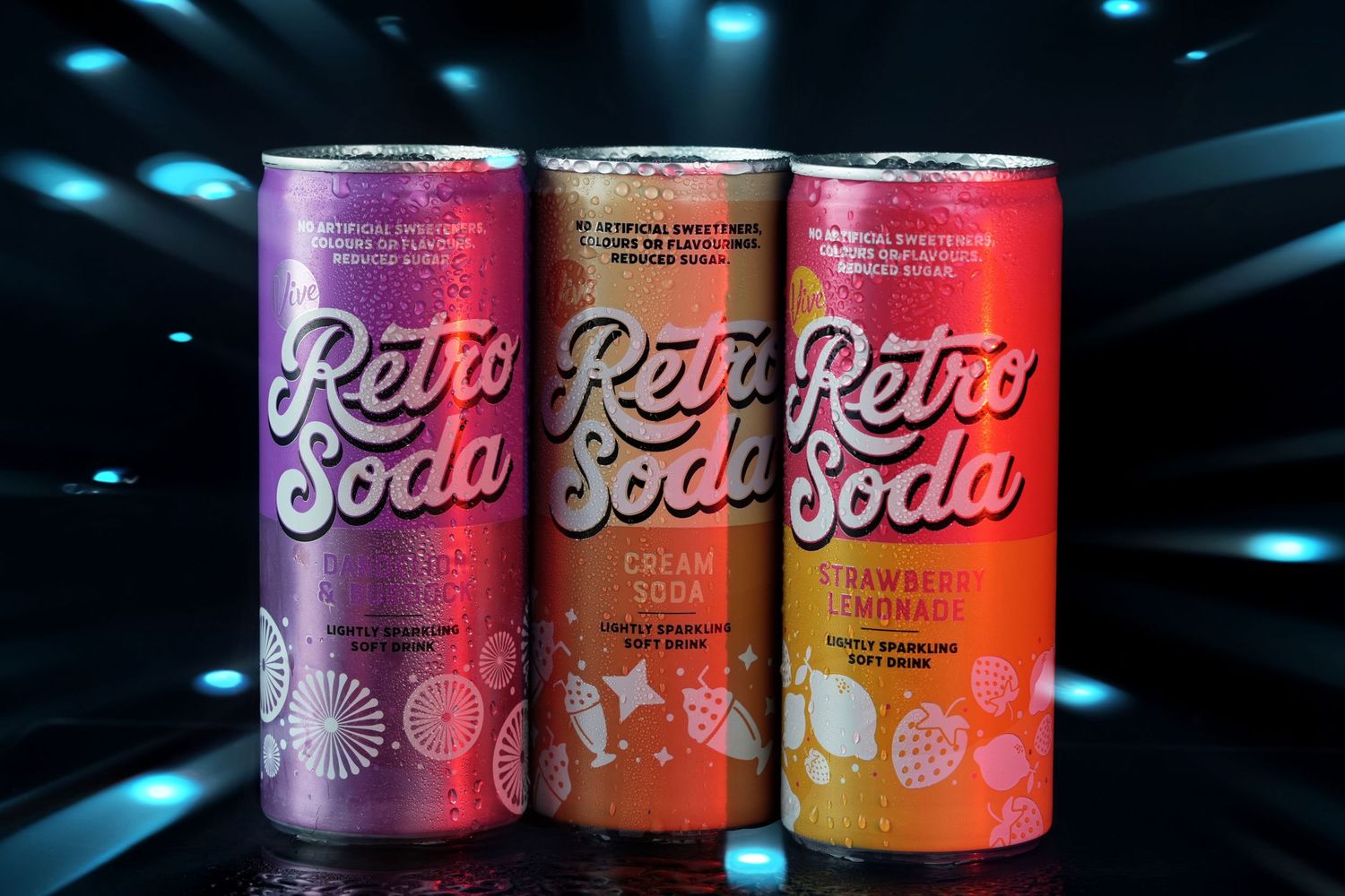 Row of colorful retro-styled beverage cans displayed under dramatic lighting.