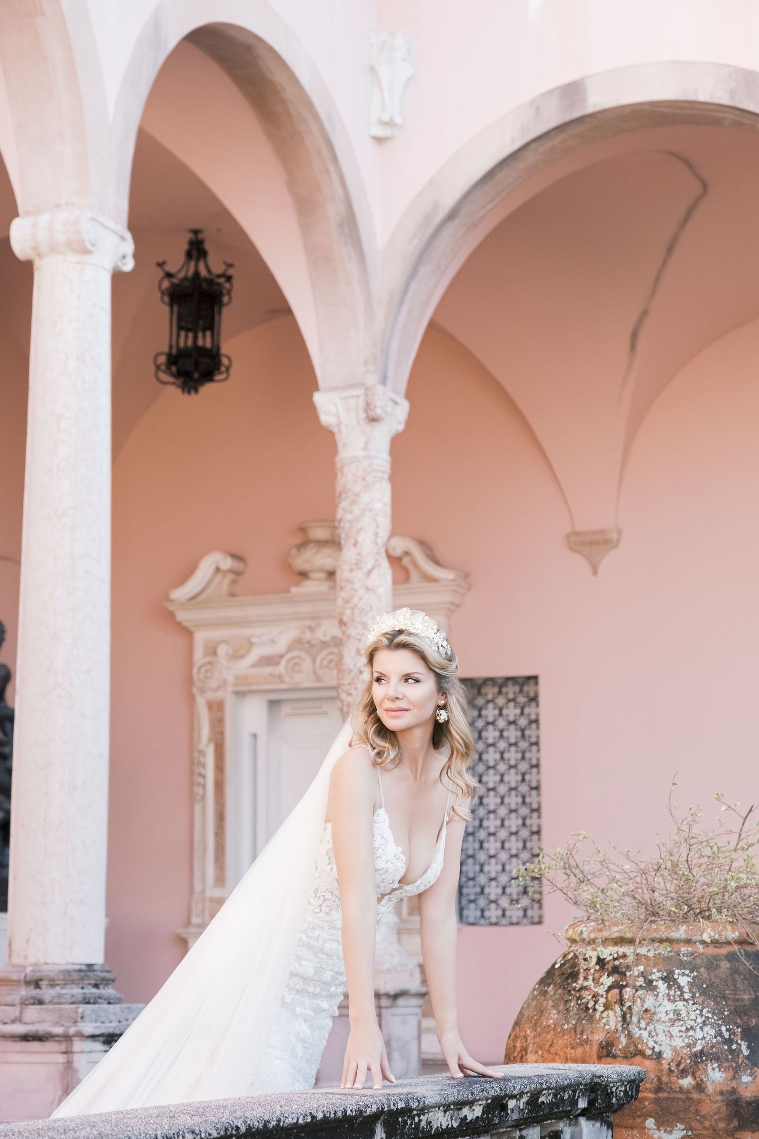 Wedding scene in an elegant white and pink room with ornate architectural details and decorative moldings. London uk photographer