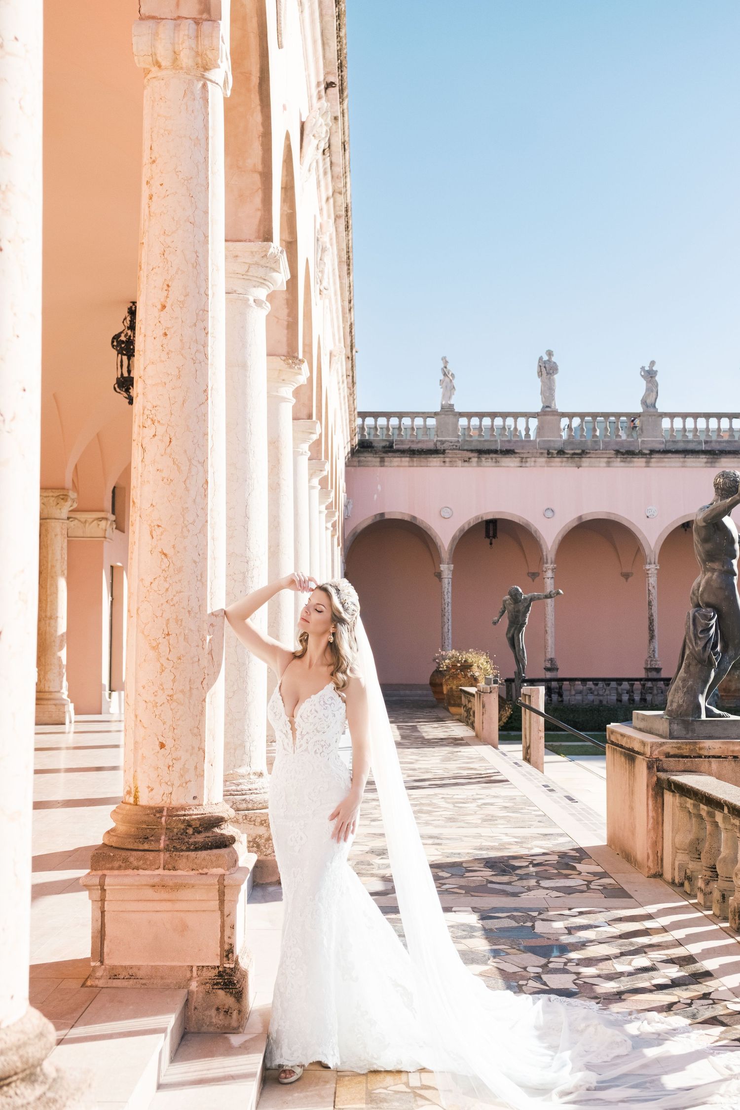 Wedding scene in an elegant white and pink room with ornate architectural details and decorative moldings. London uk photographer