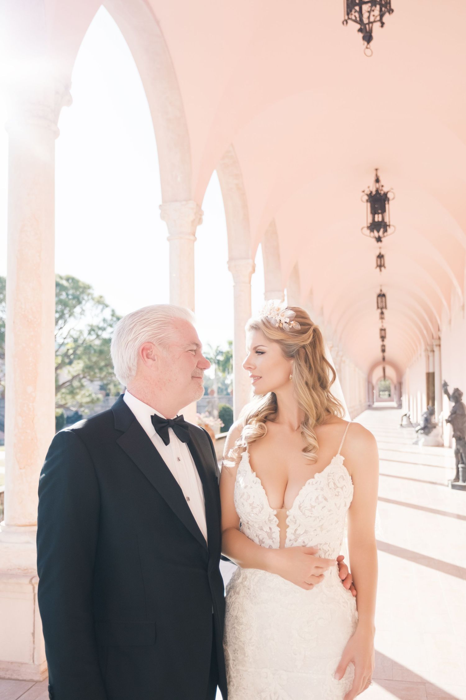 Wedding scene in an elegant white and pink room with ornate architectural details and decorative moldings. London uk photographer
