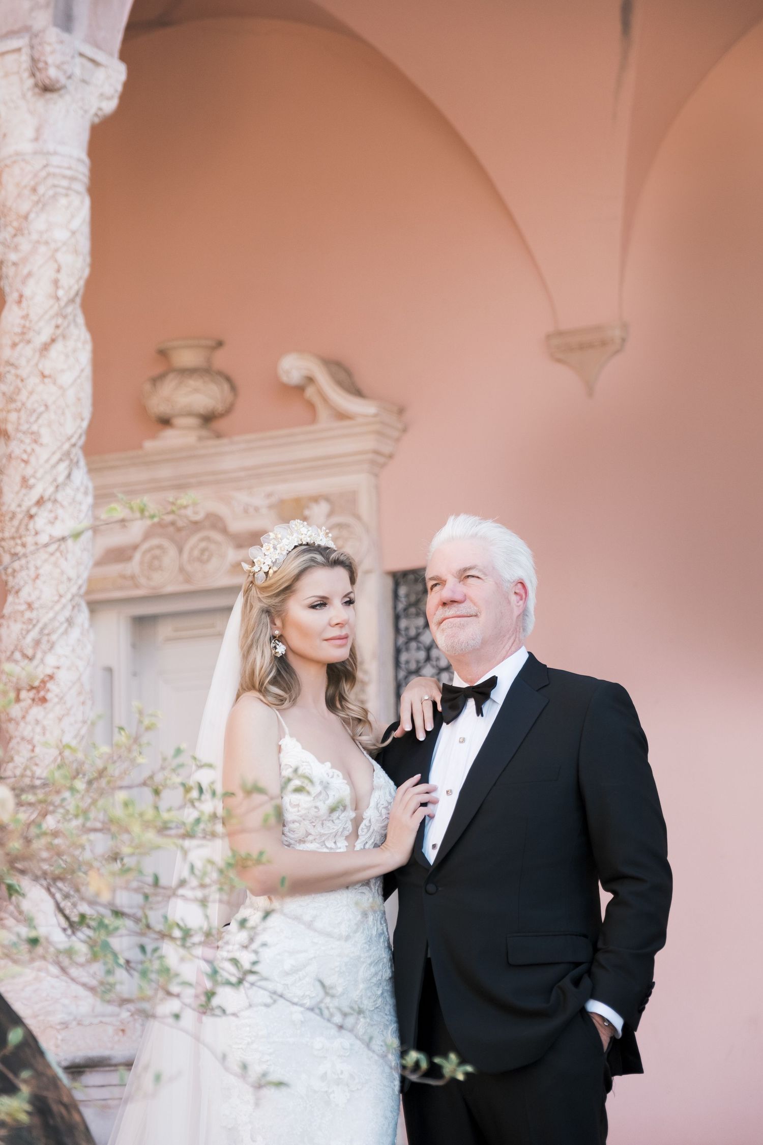 Wedding scene in an elegant white and pink room with ornate architectural details and decorative moldings. London uk photographer