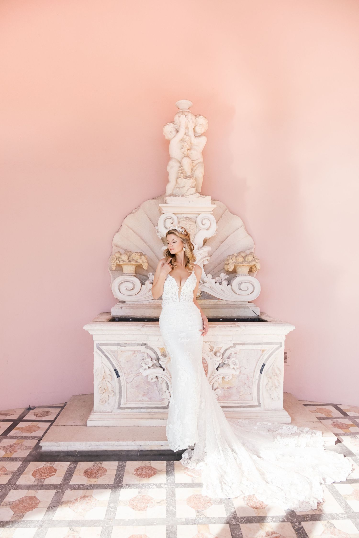 Wedding scene in an elegant white and pink room with ornate architectural details and decorative moldings. London uk photographer