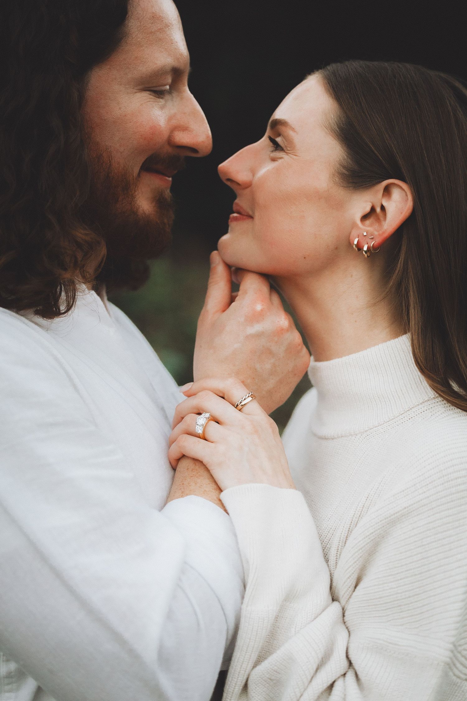 Romantic couple in matching white sweaters sharing intimate moments in a sequence of tender close-up photographs.