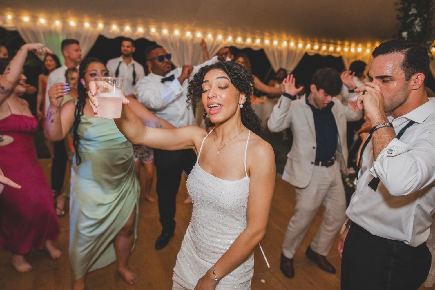 fun photo of bride on dance floor at wedding