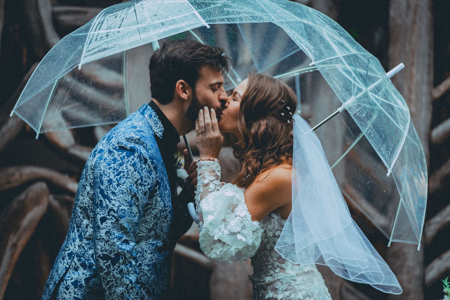 Rainy day wedding photo with clear umbrella at Baltimore's American Visionary Arts Museum